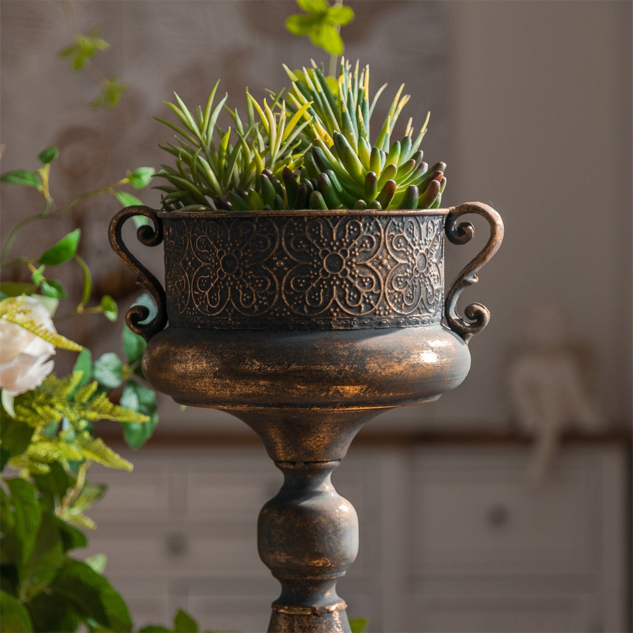 Arles urn planter pedestal base showing the aged bronze finish