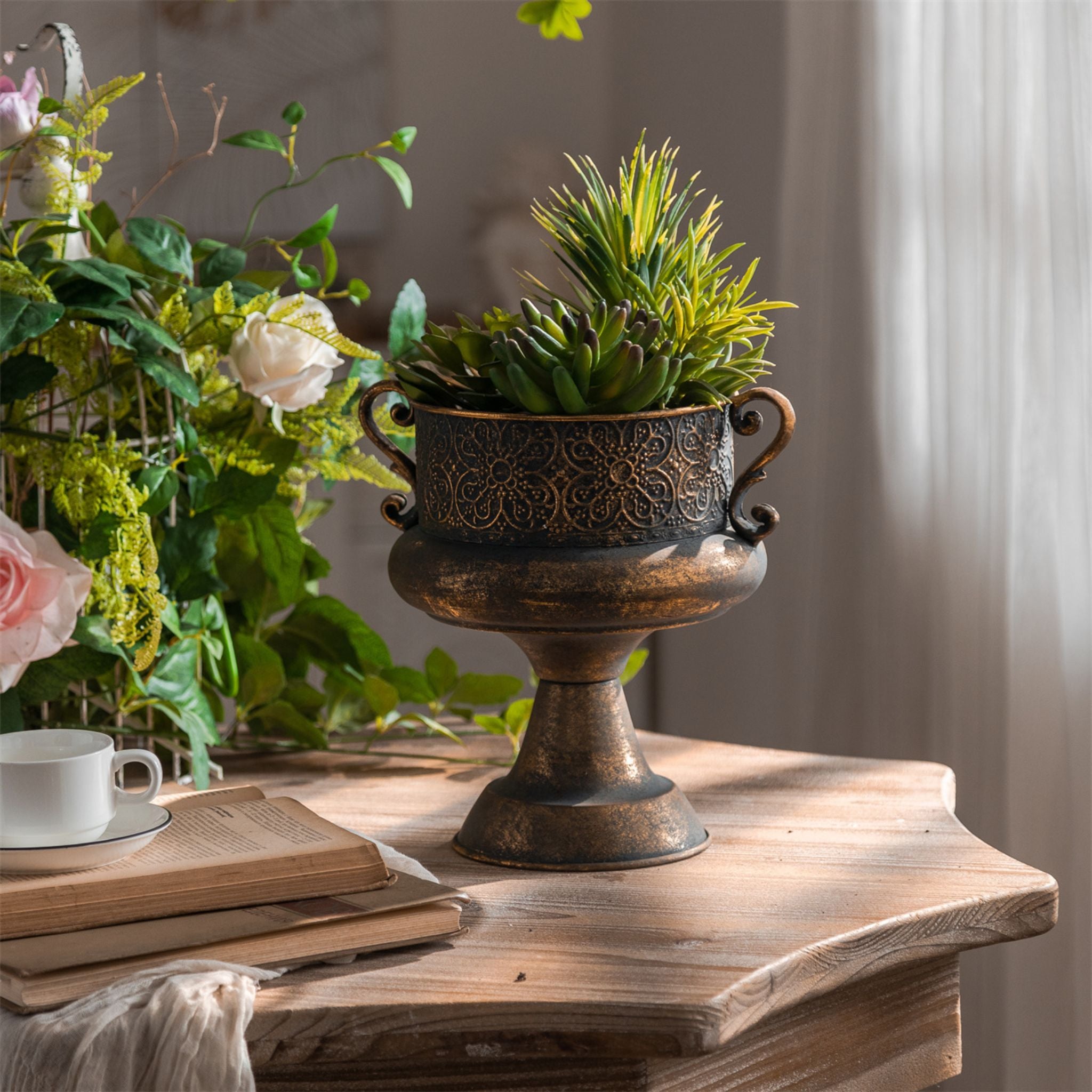 Amalfi urn planter in an aged bronze finish with embossed floral band and scroll handles