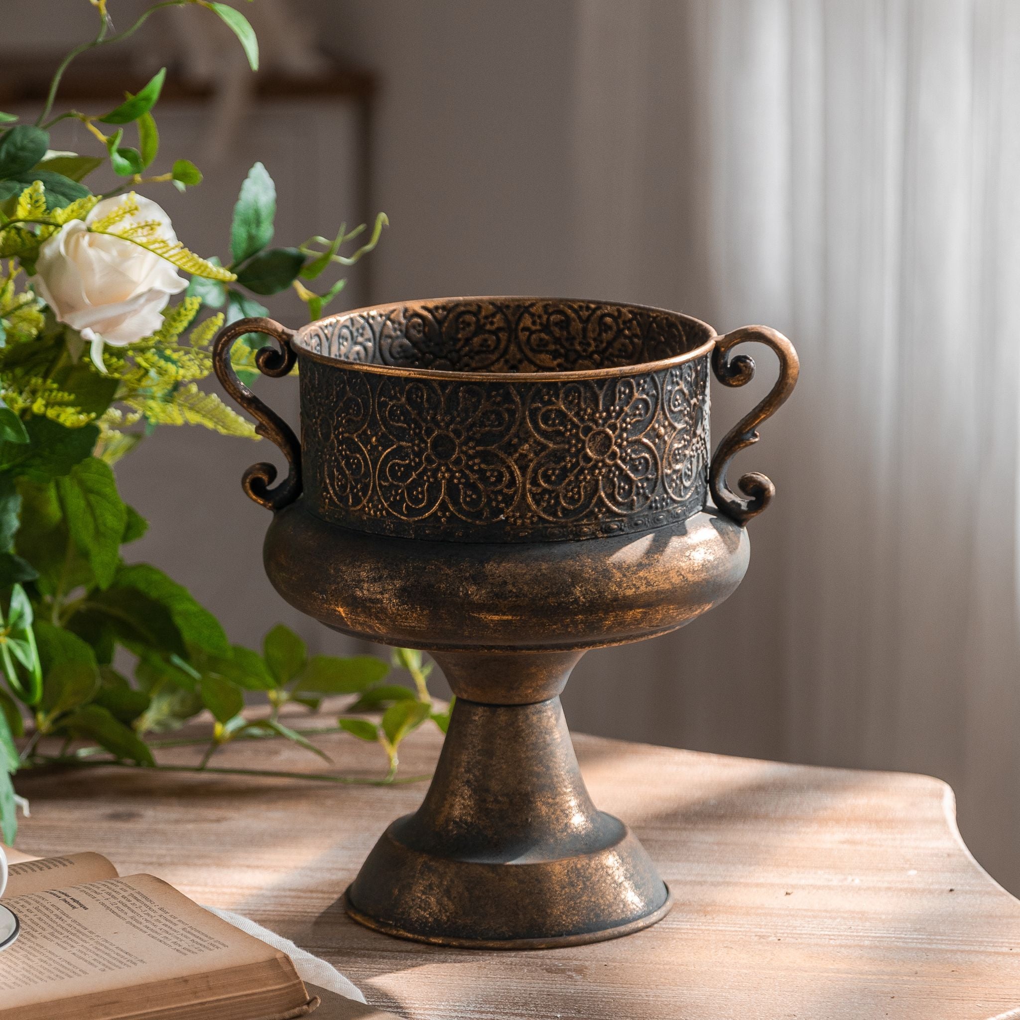 Close view of the embossed floral band and scroll handle on the Amalfi urn planter