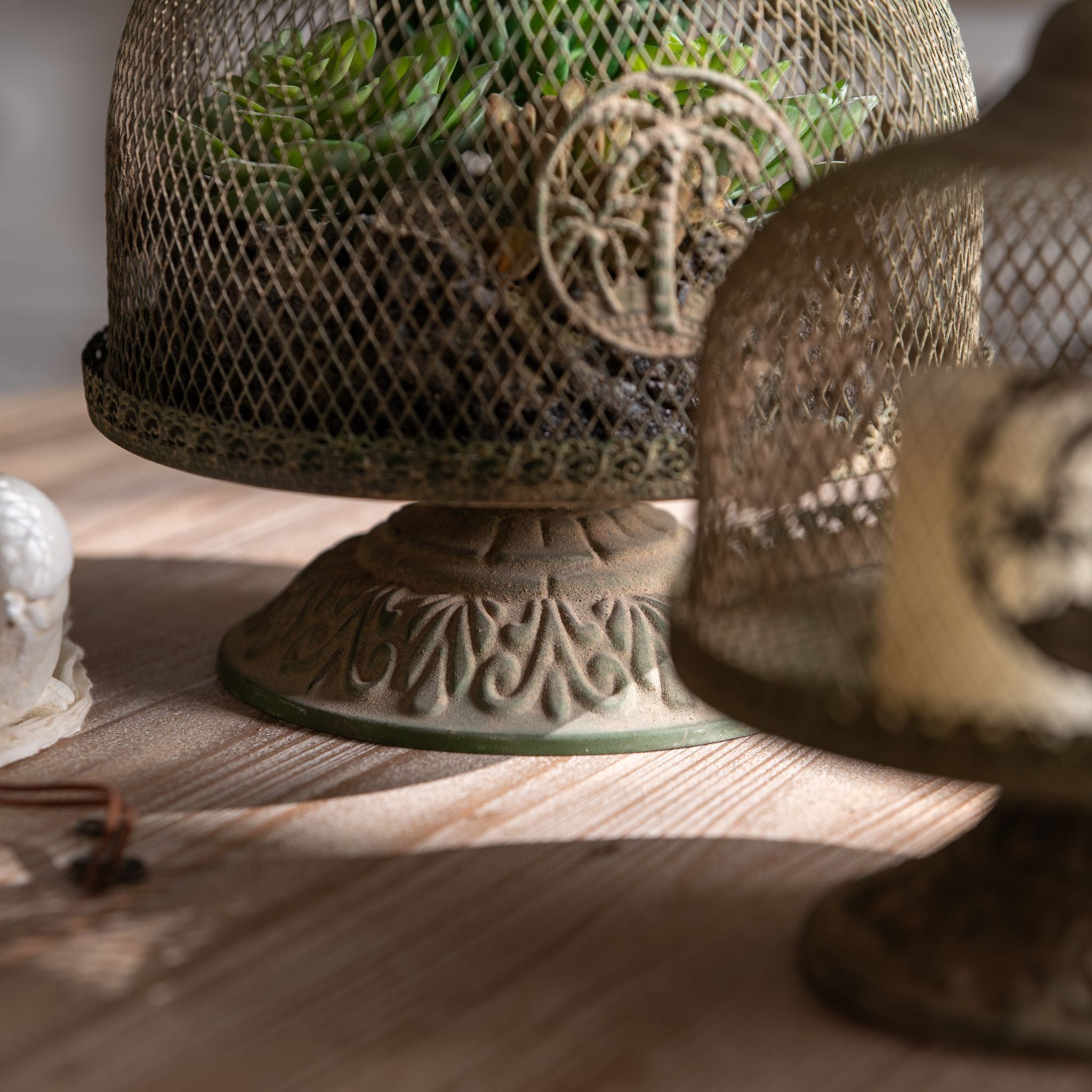 Close view of the Primo cloche dome, finial, and embossed pedestal base