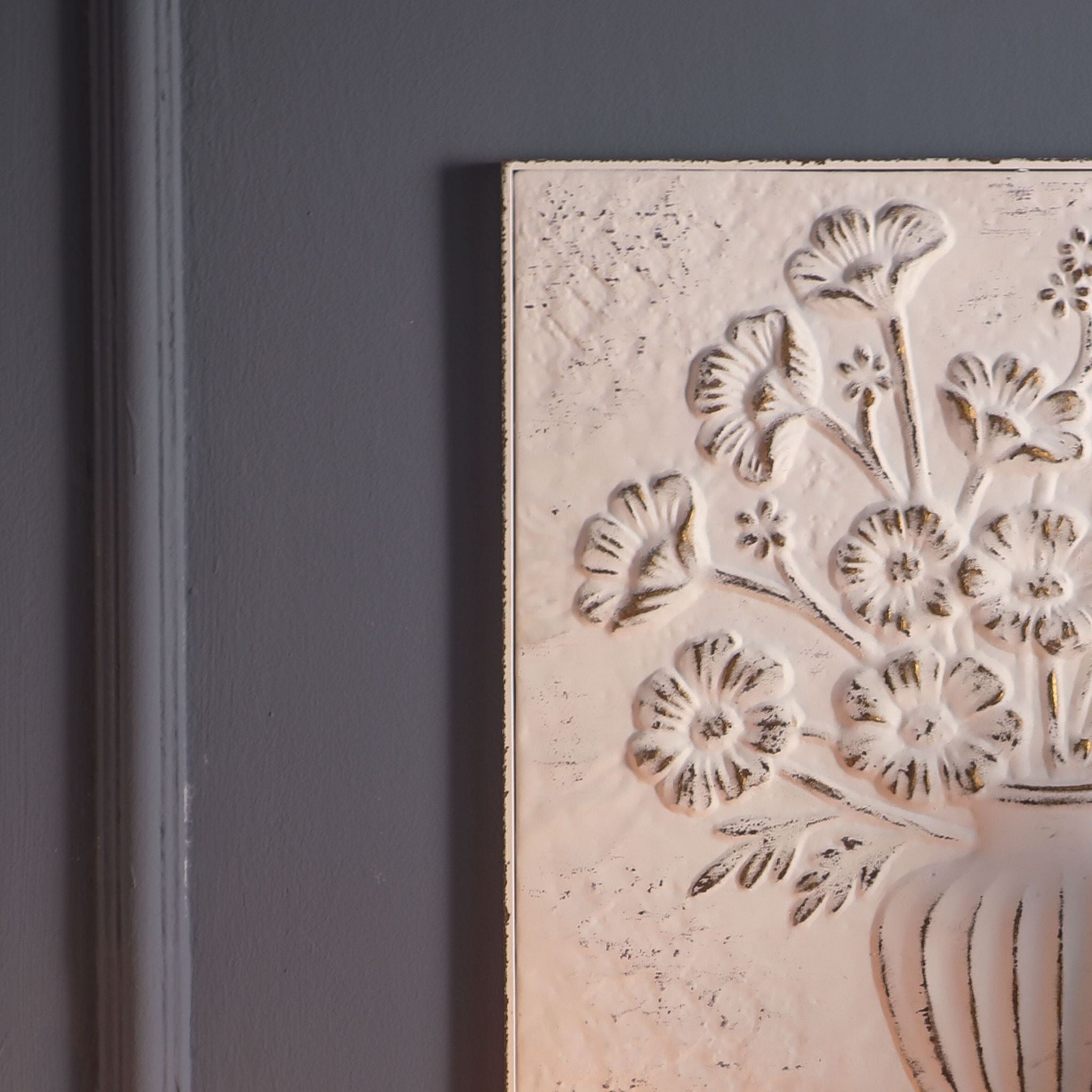Pia wall panel hung on a dark wall above a sideboard with candlelight and autumn stems