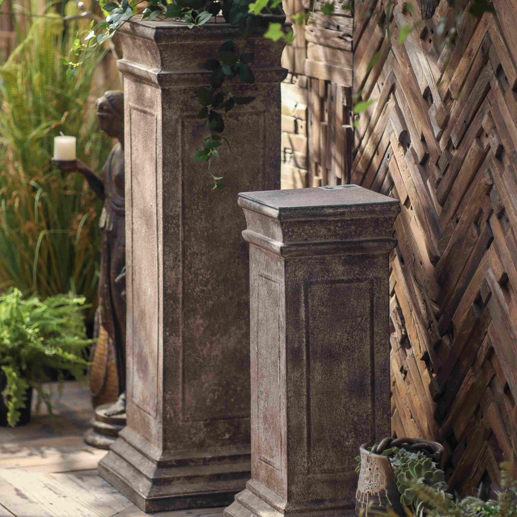 Close view of the panelled side and mottled aged finish on the Petra pedestal