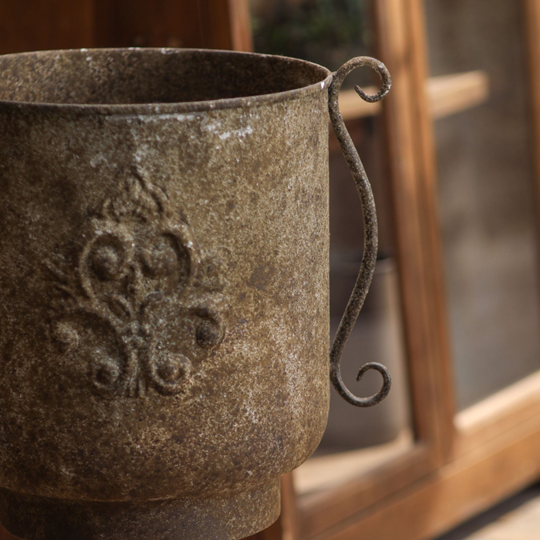 Detail of the curled scroll handle on the side of the Gloria urn planter