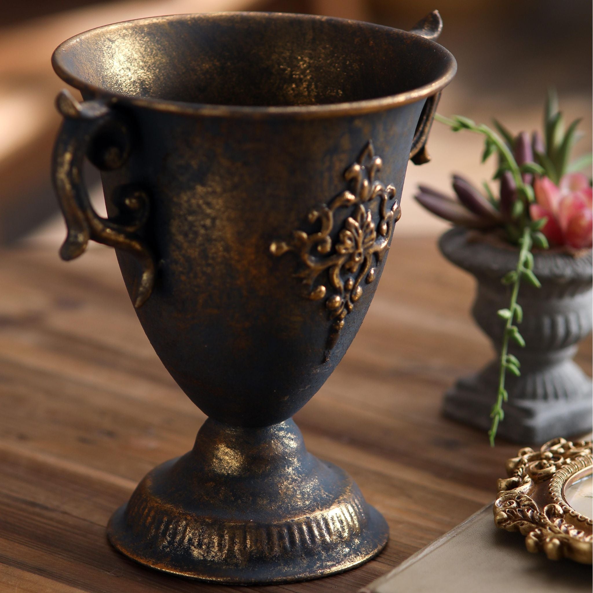 Detail of the curled scroll handle and fluted foot on the Isla goblet urn