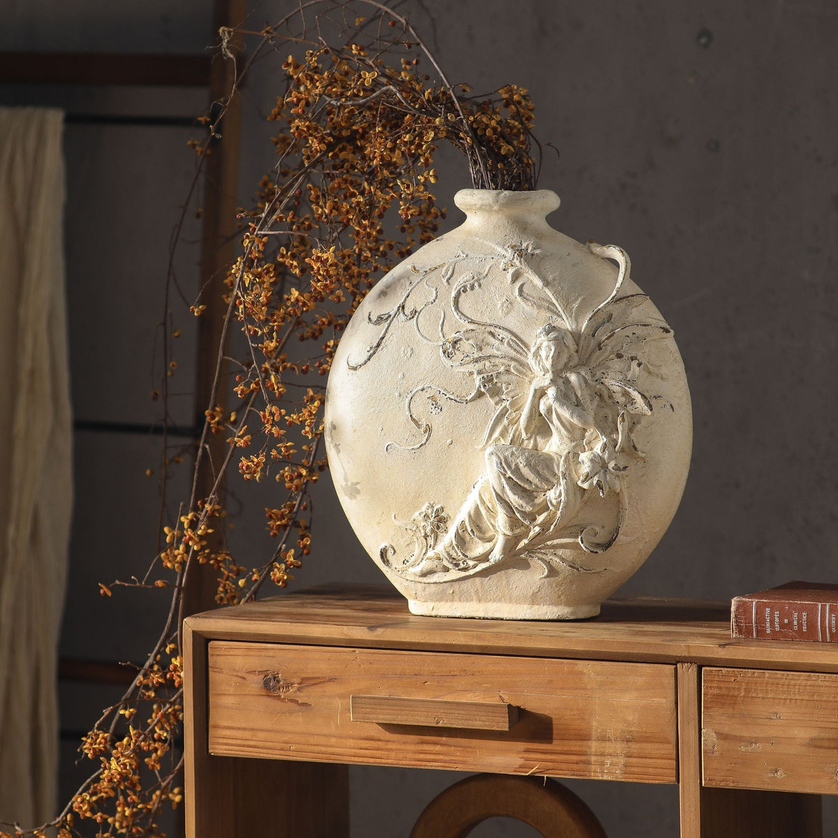 Mélusine vase from a side angle, showing the loop handles at the shoulder and the depth of the relief
