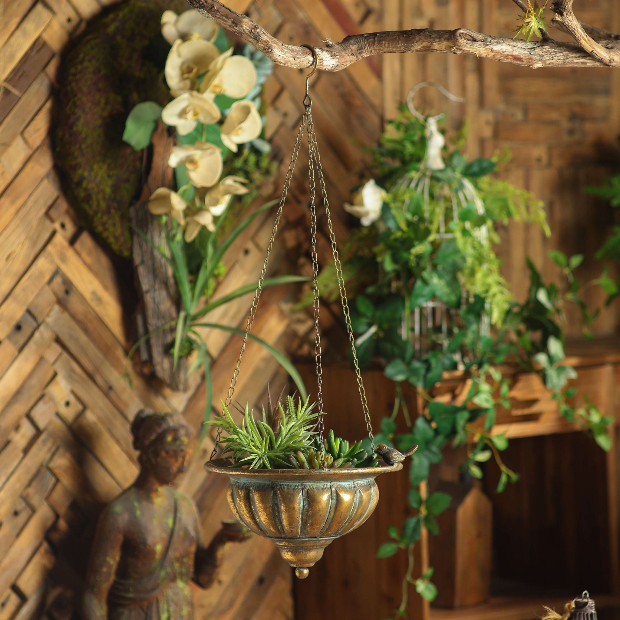 Nera hanging planter in antique gold with perched birds holding succulents from a branch