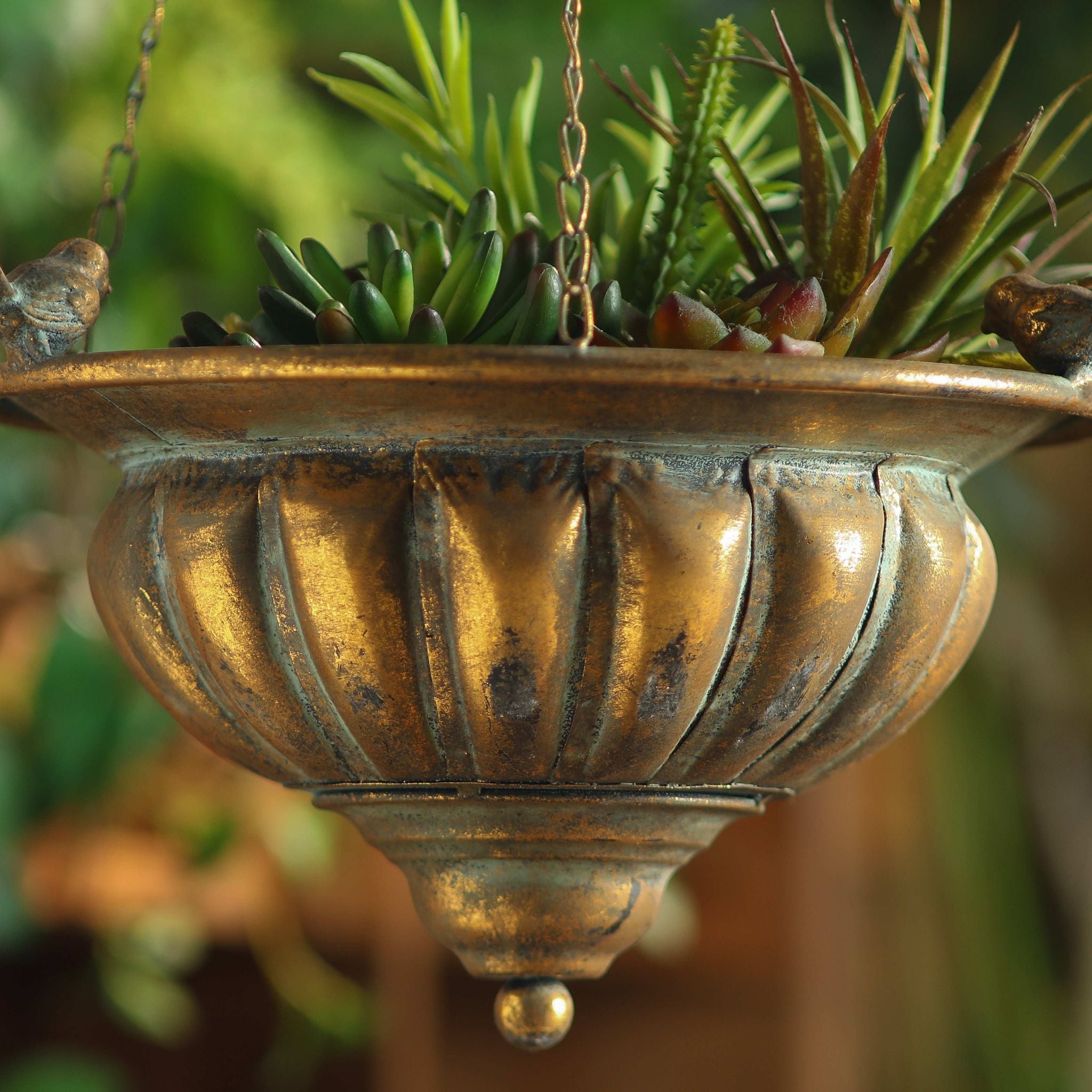 The three chains of the Nera hanging planter gathered to a hook on a branch