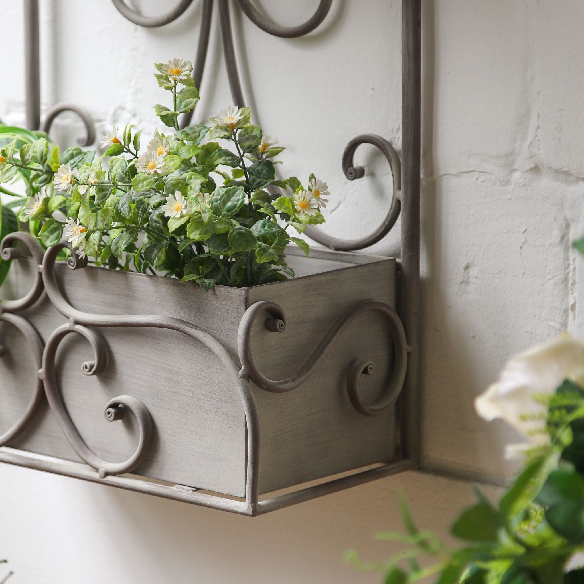 Close view of the curled pediment and scrollwork on the top box of the Avignon planter