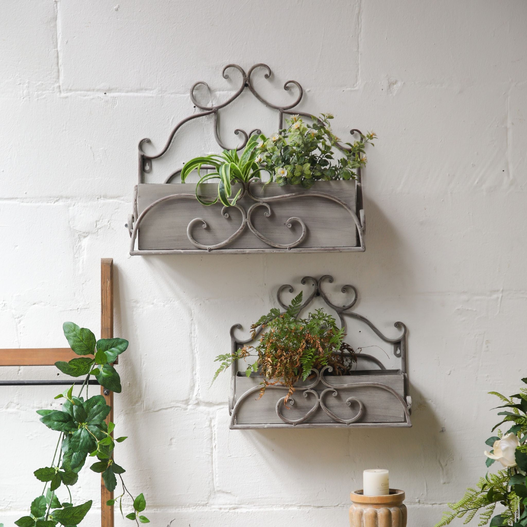 Bianca wall planter set of two in scrolled grey iron staggered on a white brick wall