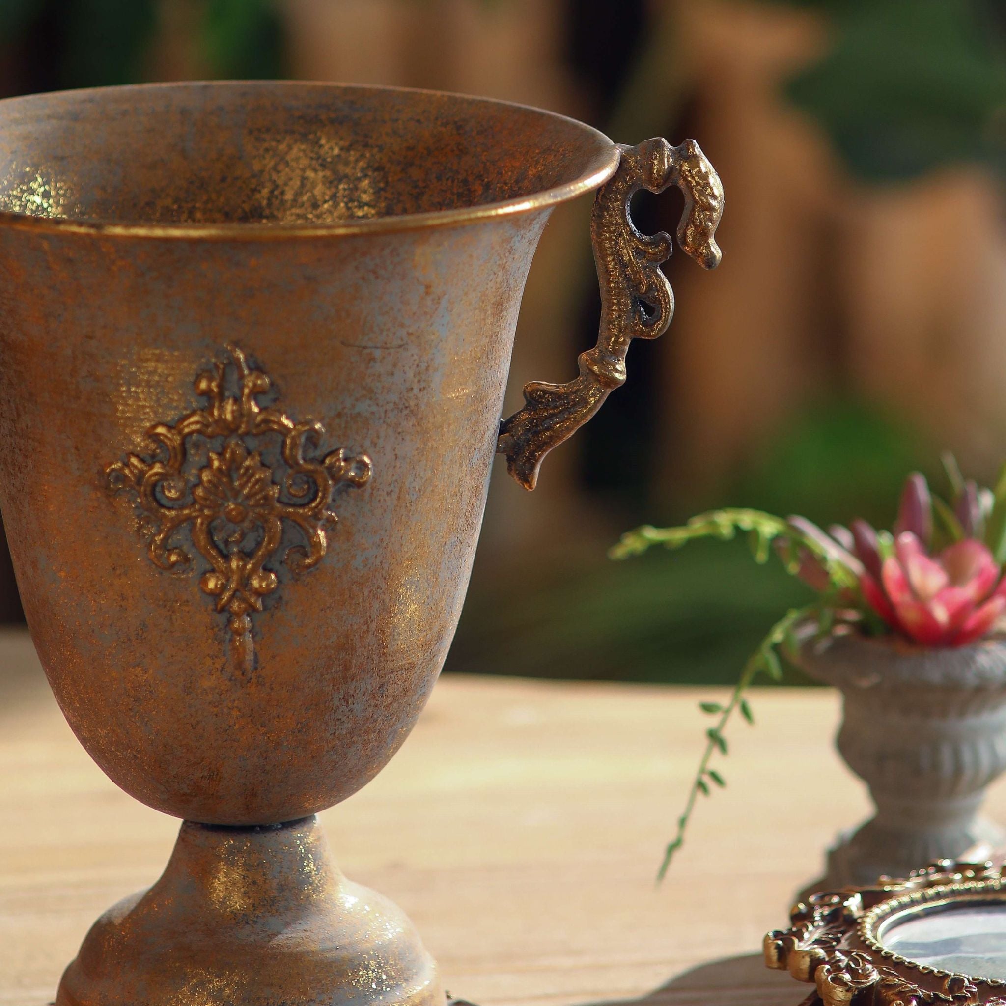 Bruno rust and gold urn holding dried lavender and wildflowers in warm light