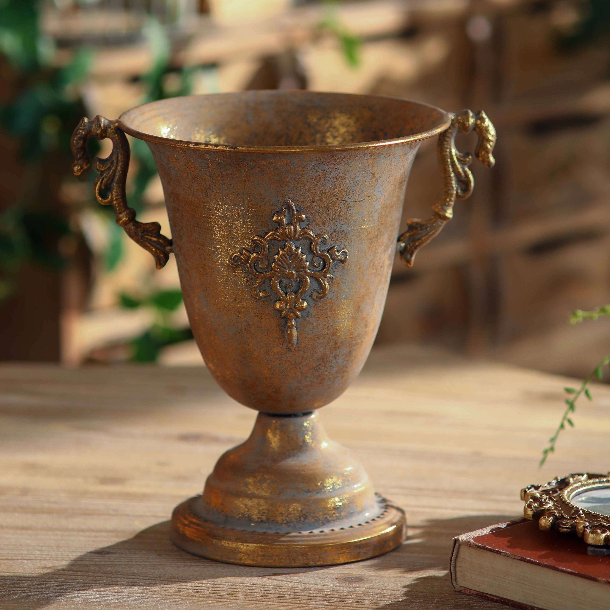 Close view of the raised damask emblem and ornate handle on the Bruno urn