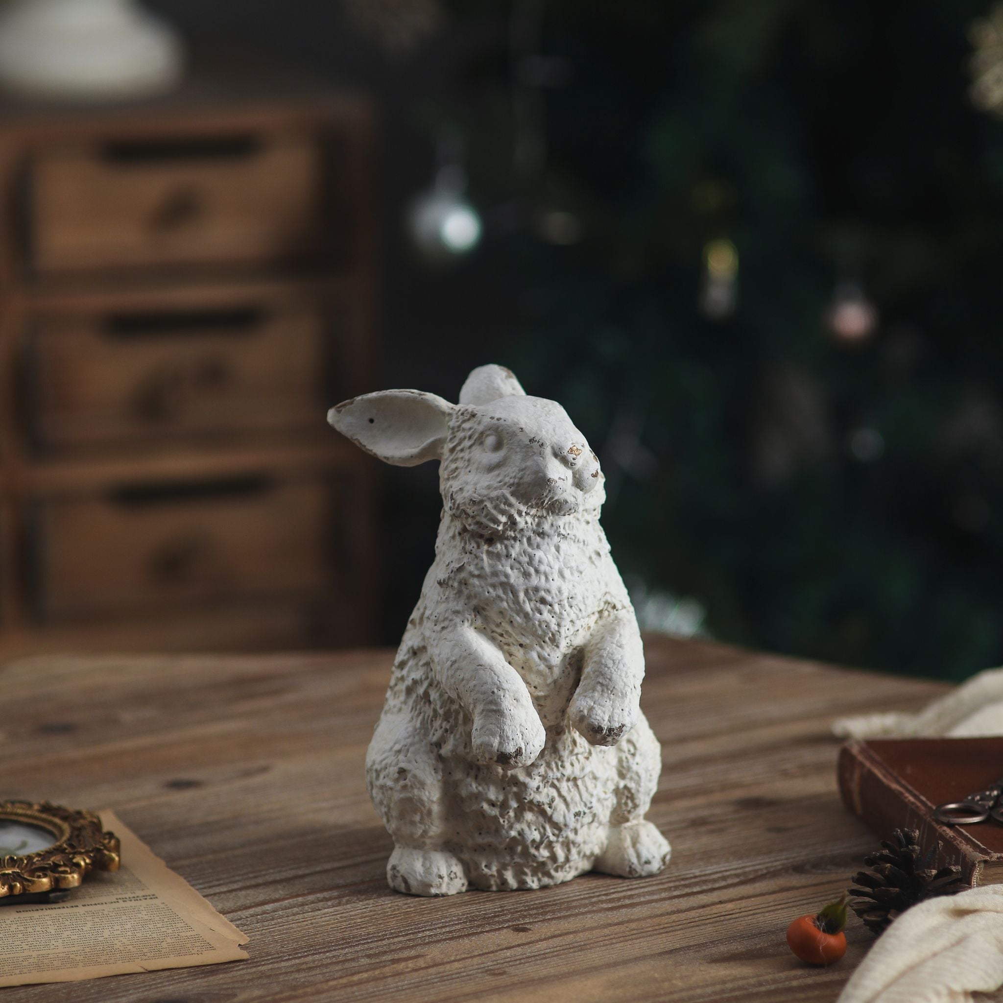 Dalia rabbit statue in distressed white sitting upright on a timber table
