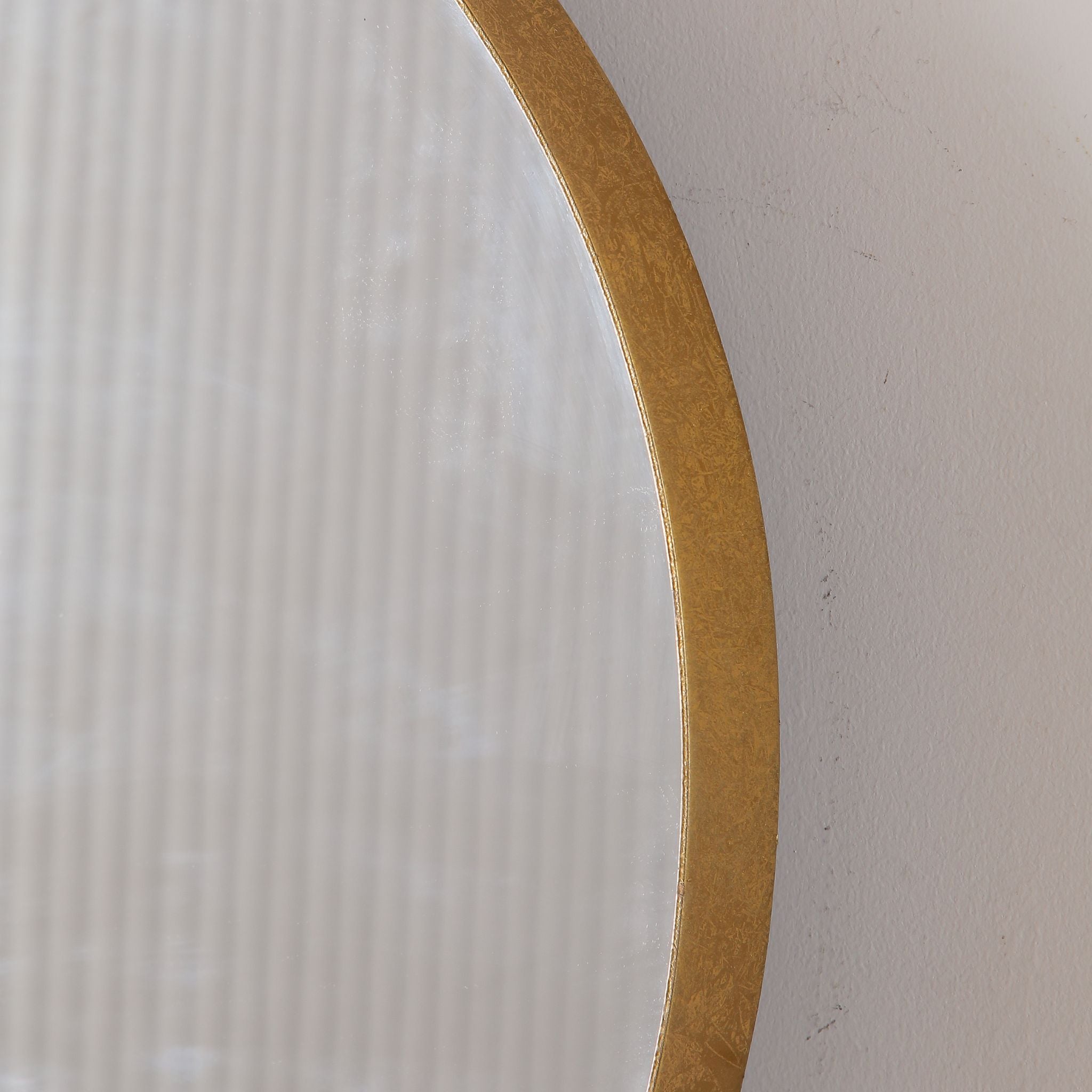Elvira round mirror close-up detail of the hand-finished antique gold frame edge