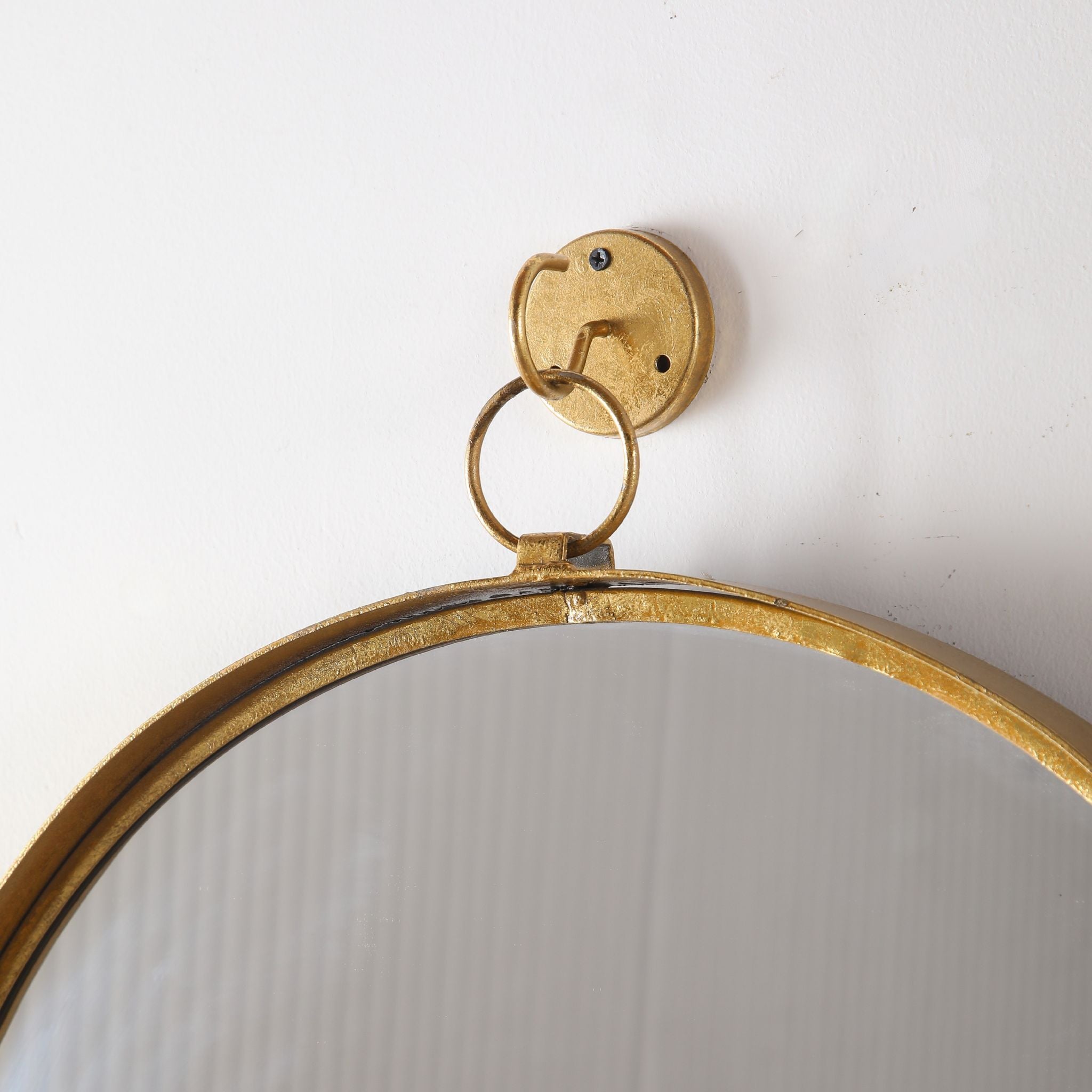 Elvira wall mirror close-up of the included gold wall bracket and hanging ring