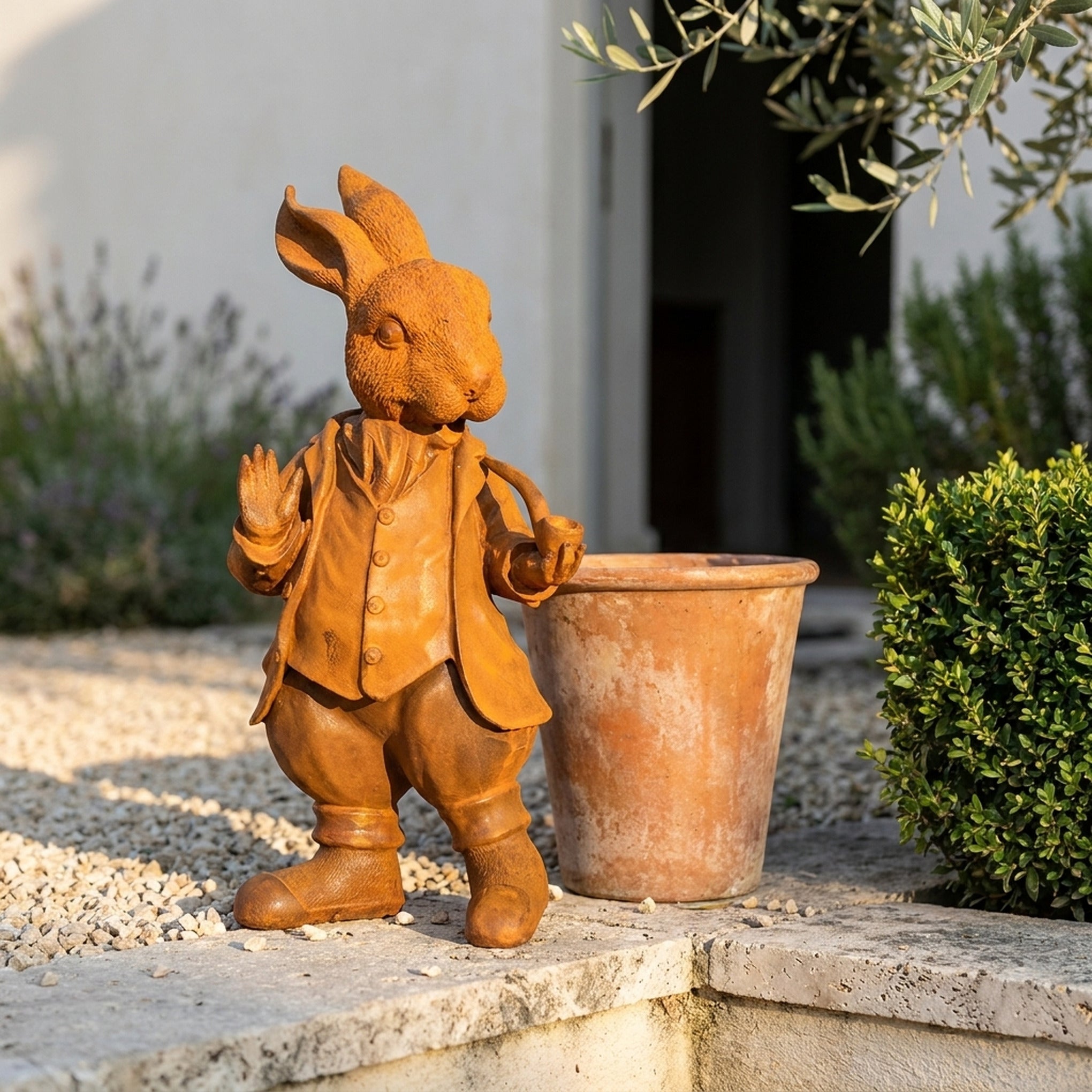 Mayor Cottontail Large rabbit statue three quarter view in a provencal courtyard
