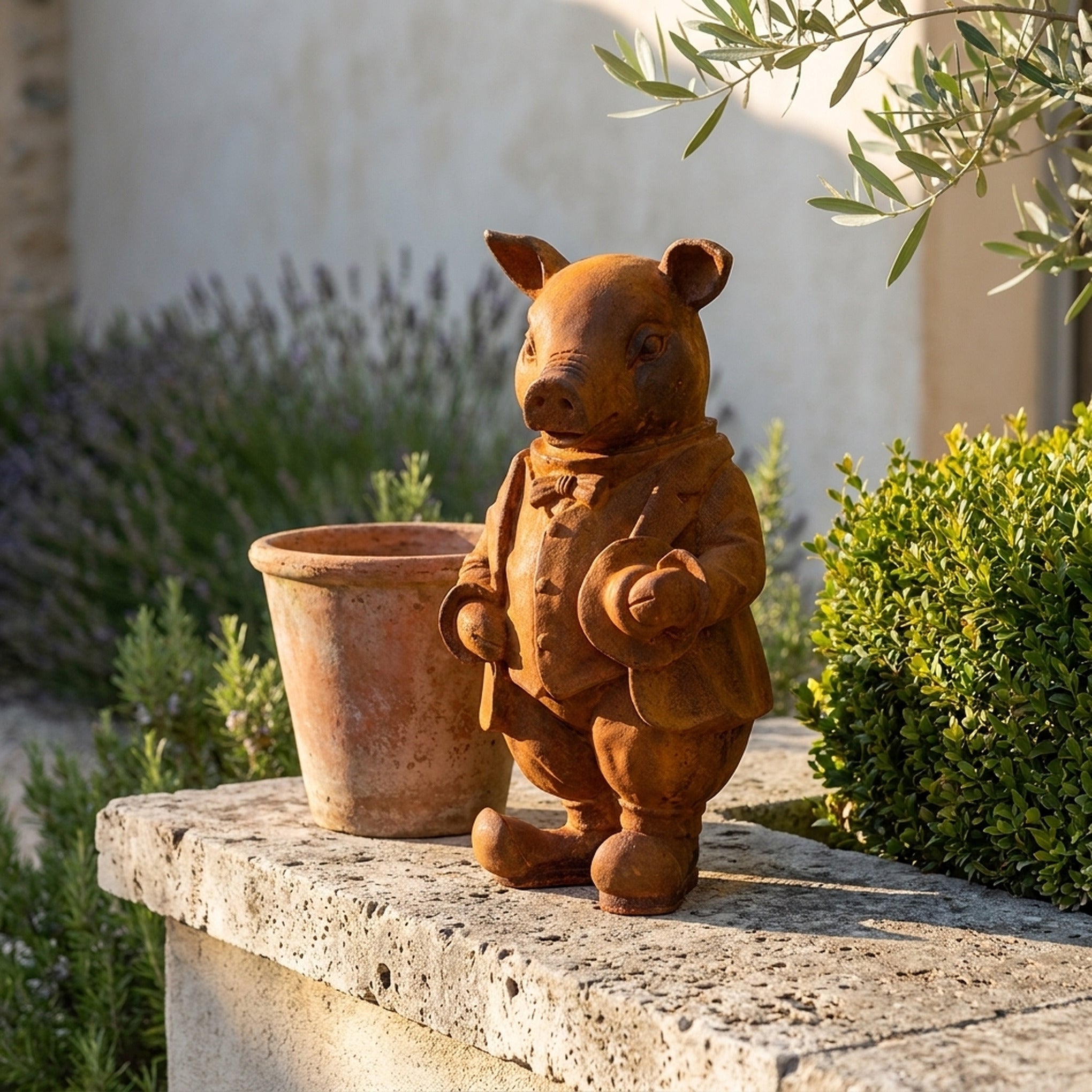 Inspector Truffles rust cast iron pig statue in a bow tie holding a hat, on a travertine ledge beside a terracotta pot