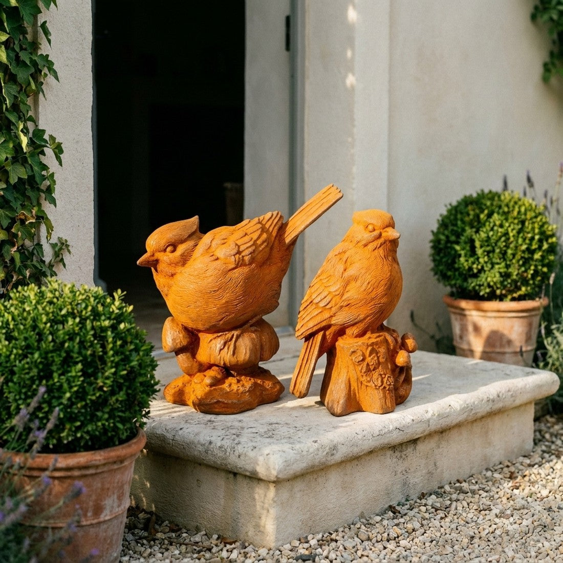 Pip and Squeak cast iron bird statues side view showing the cocked tail and the tree stump base