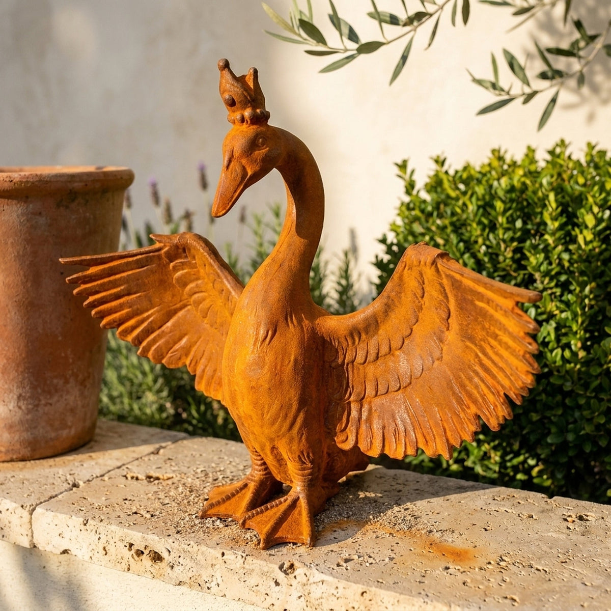 Princess Evangeline crowned goose statue front view beside a terracotta pot for scale