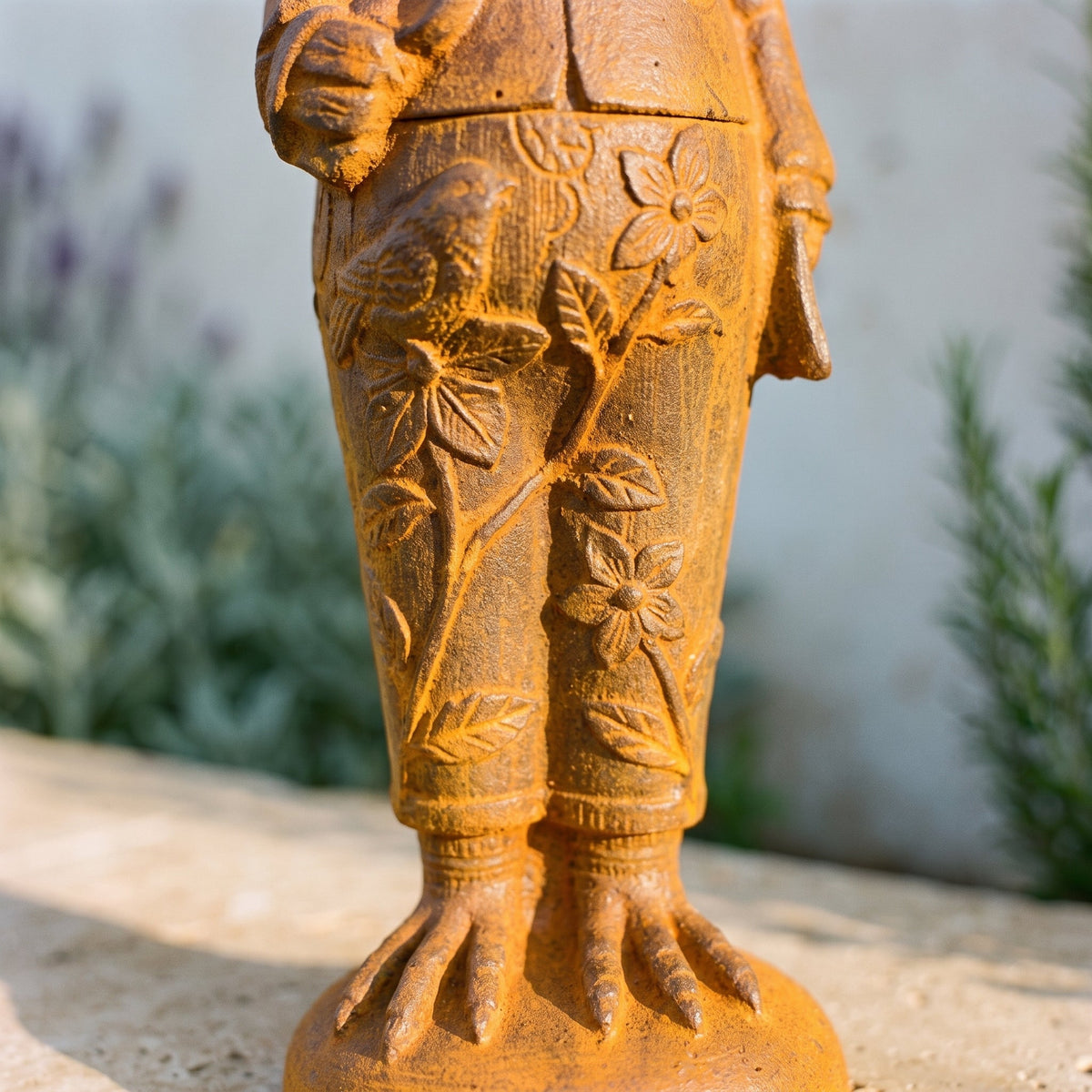 Mr Featherwick cast iron rooster statue, macro detail of the raised floral and leaf vine cast into the trousers