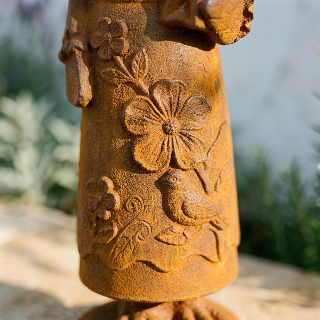Mrs Cluckington cast iron hen statue, macro detail of the raised five petal flower and trailing leaves on the skirt