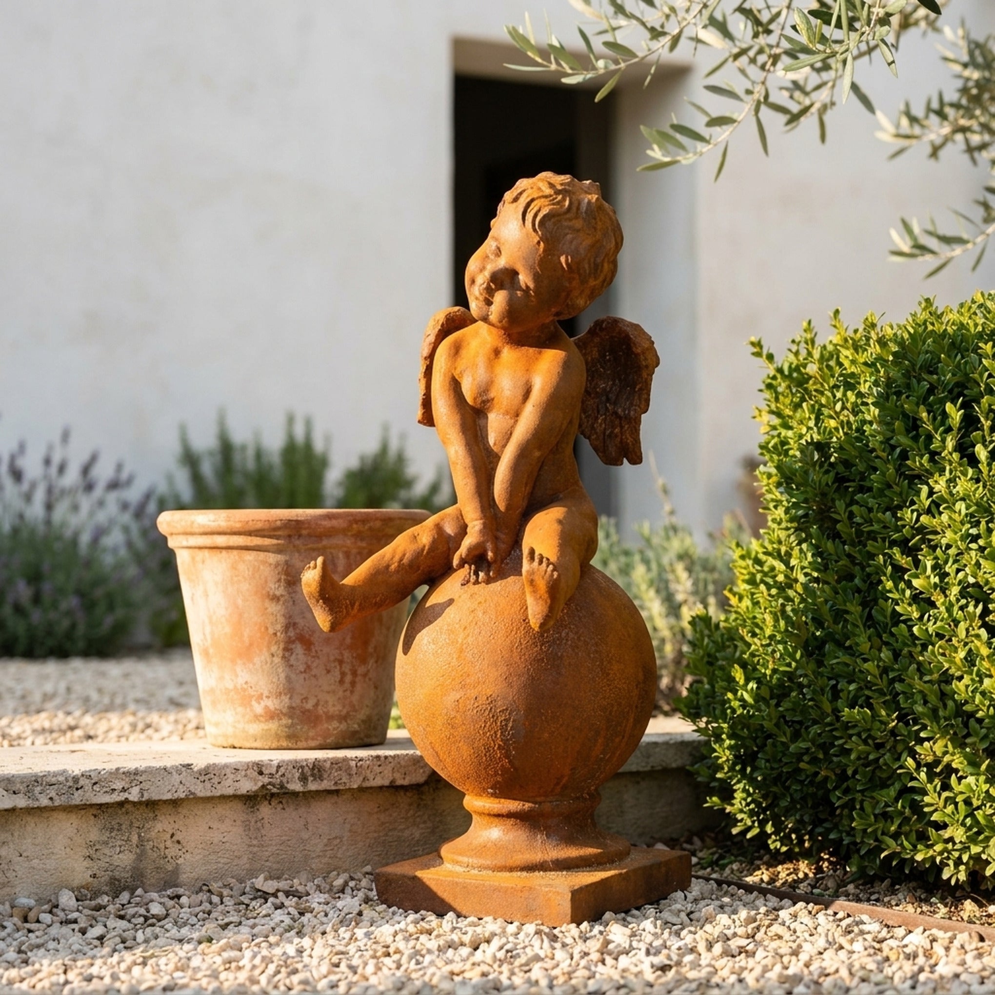 Hugo Wingsley cherub statue three quarter view in a provencal courtyard