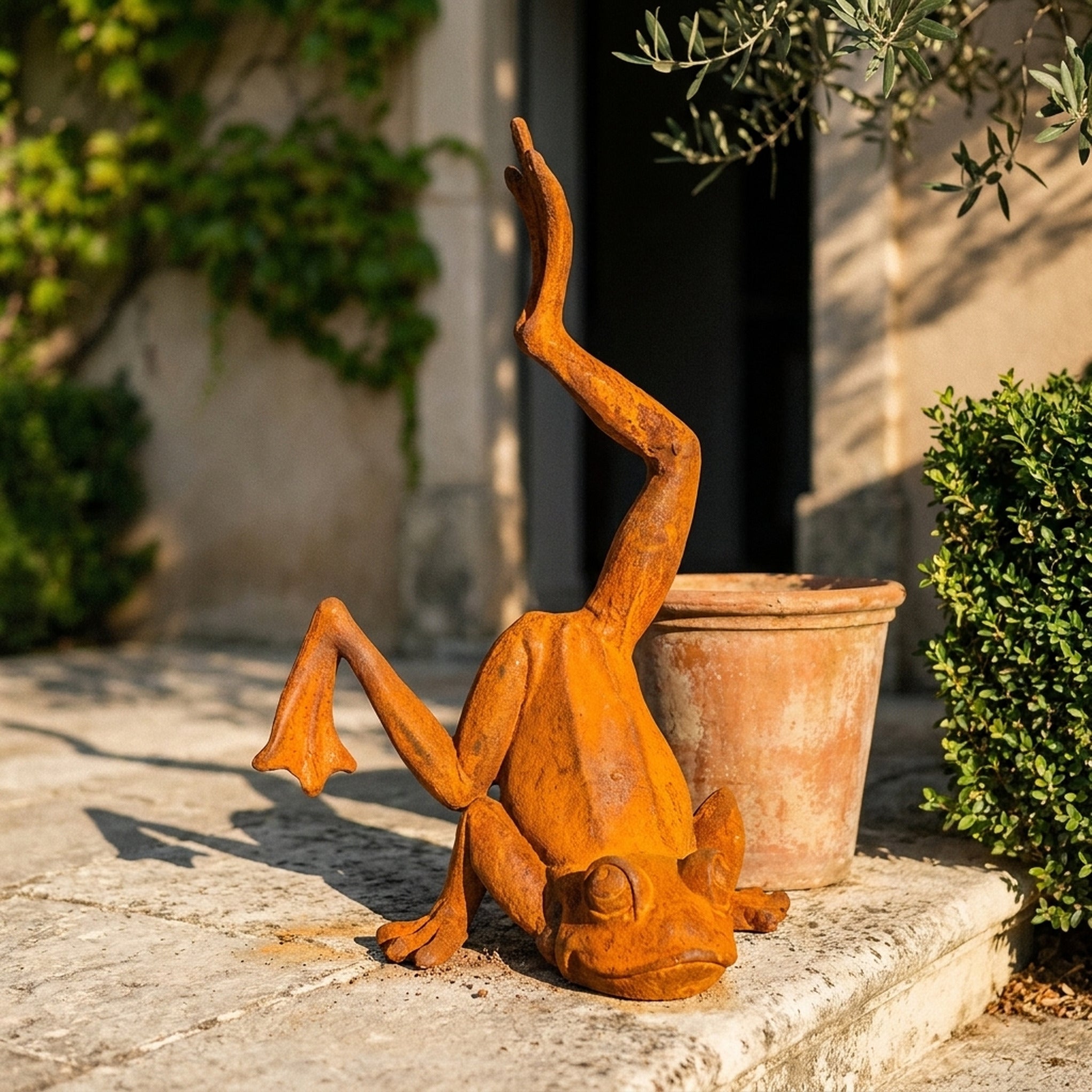 Major Ribbit handstand frog statue three quarter view in a provencal courtyard