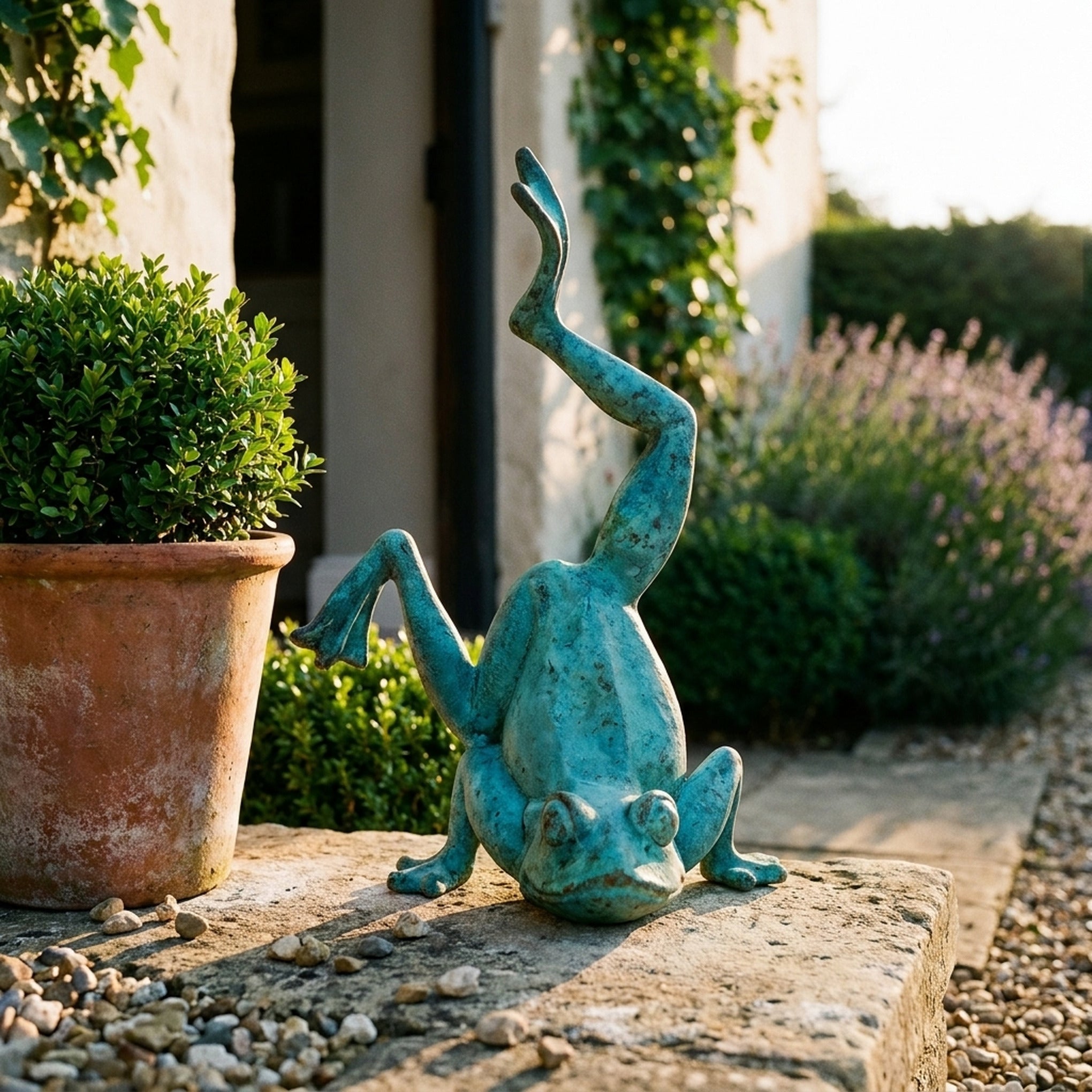 Major Ribbit Verdigris handstand frog statue three quarter view in a provencal courtyard