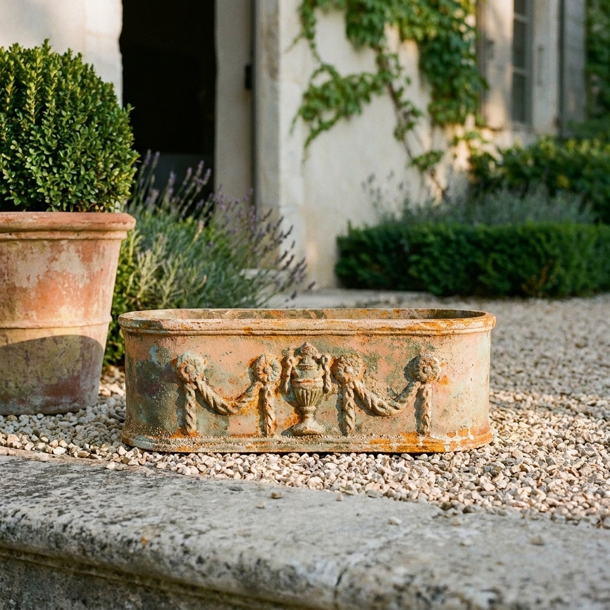 The Heritage Planter Antique cast iron trough planter three quarter view in a provencal courtyard
