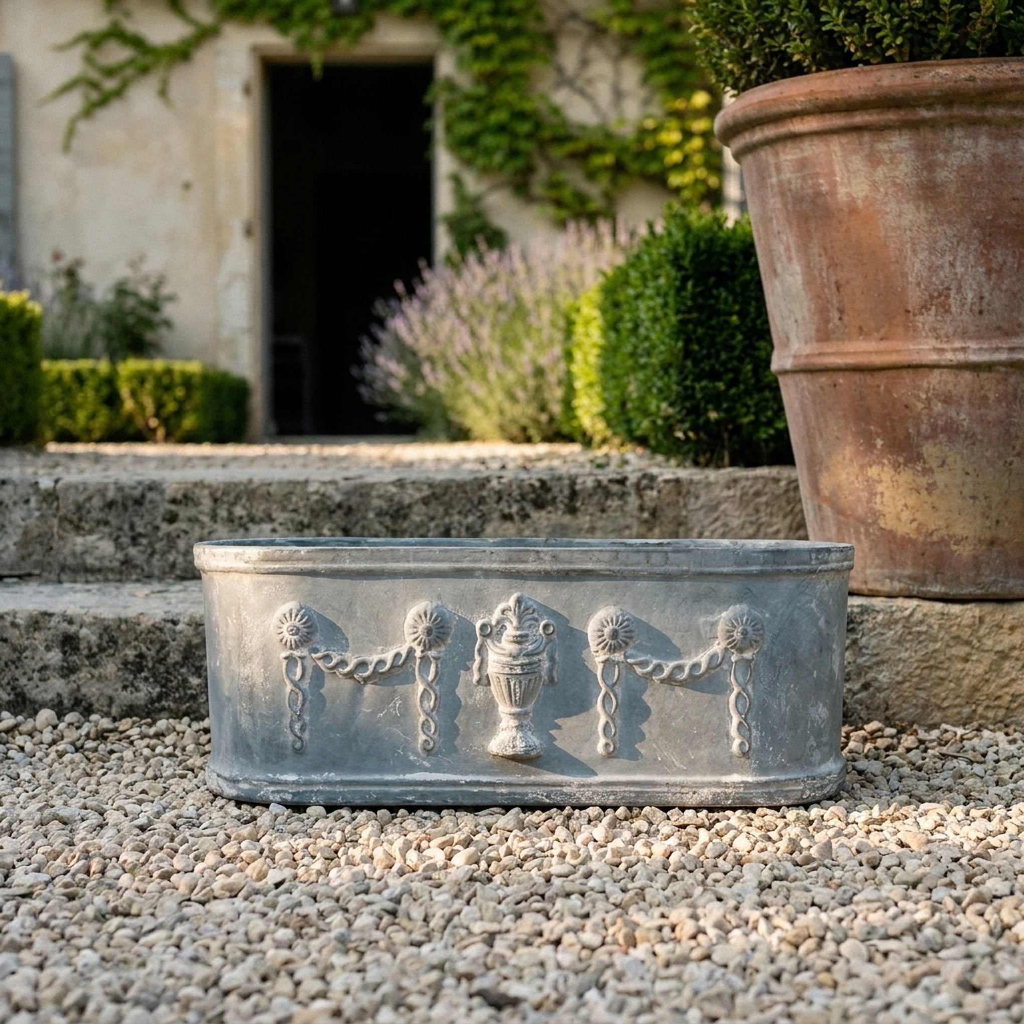 The Heritage Planter Grey close view of the urn and swag relief
