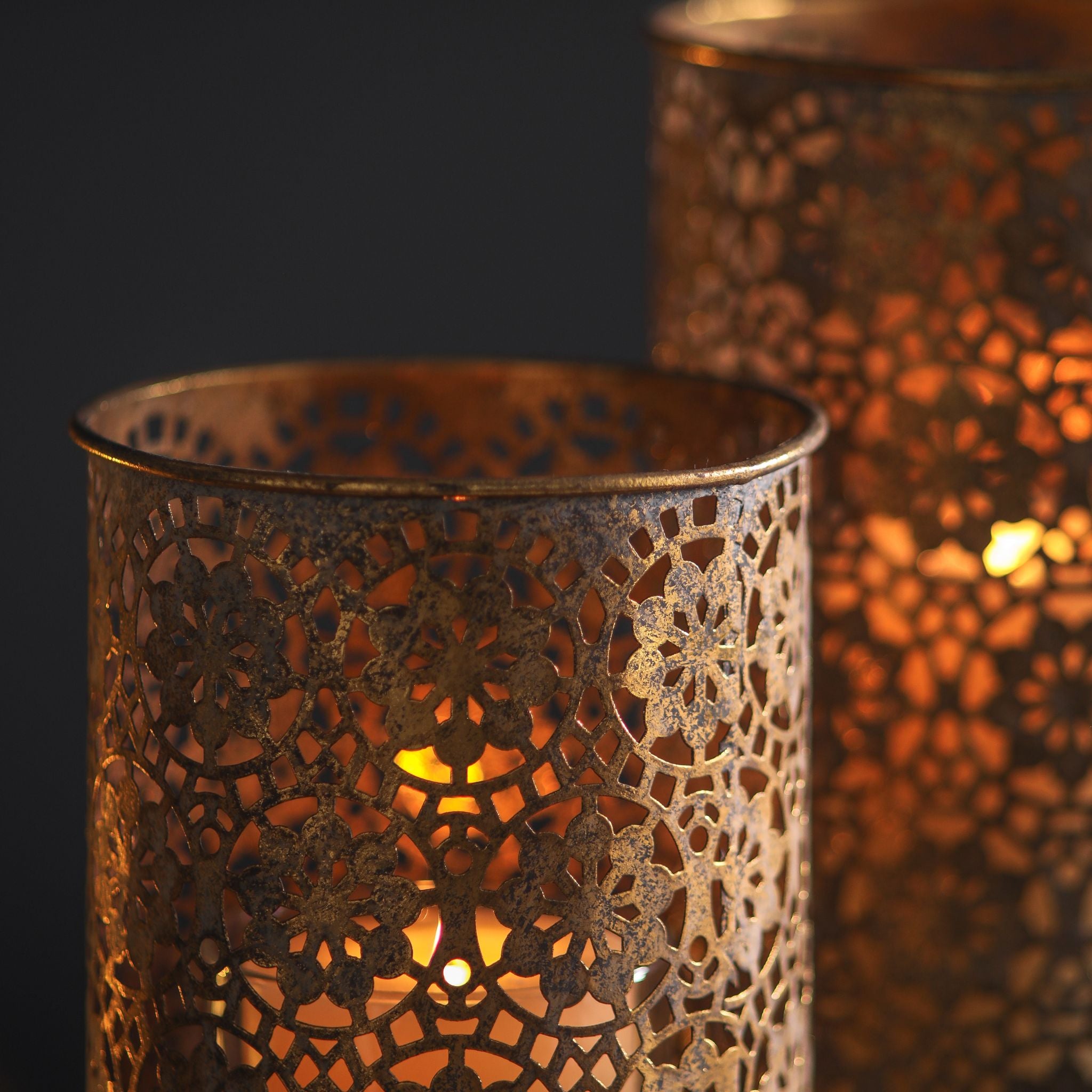 Paros candle holder close-up of candlelight glowing through the pierced floral lacework