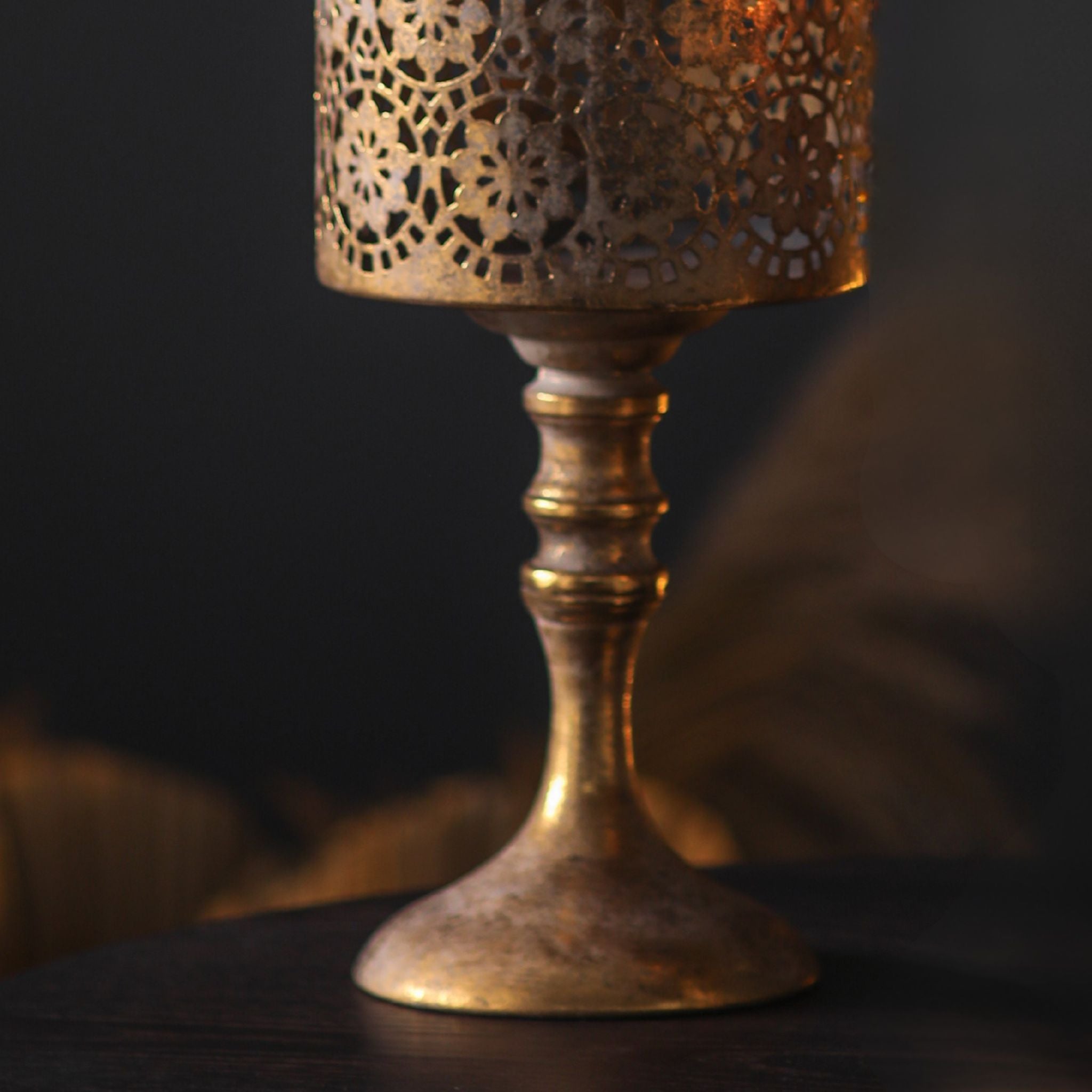 Paros candle holder detail of the turned antique gold pedestal base