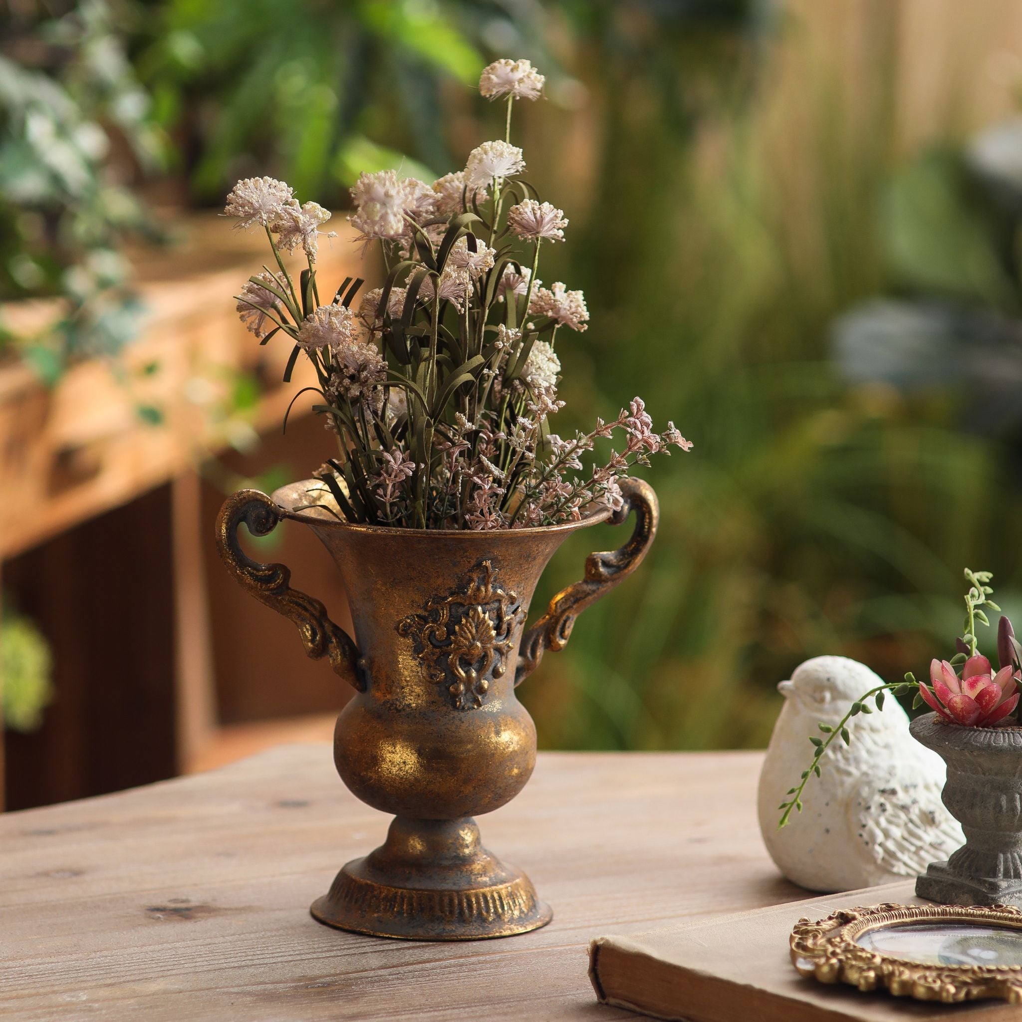 Lorenzo urn vase styled with dried stems beside a white bird ornament