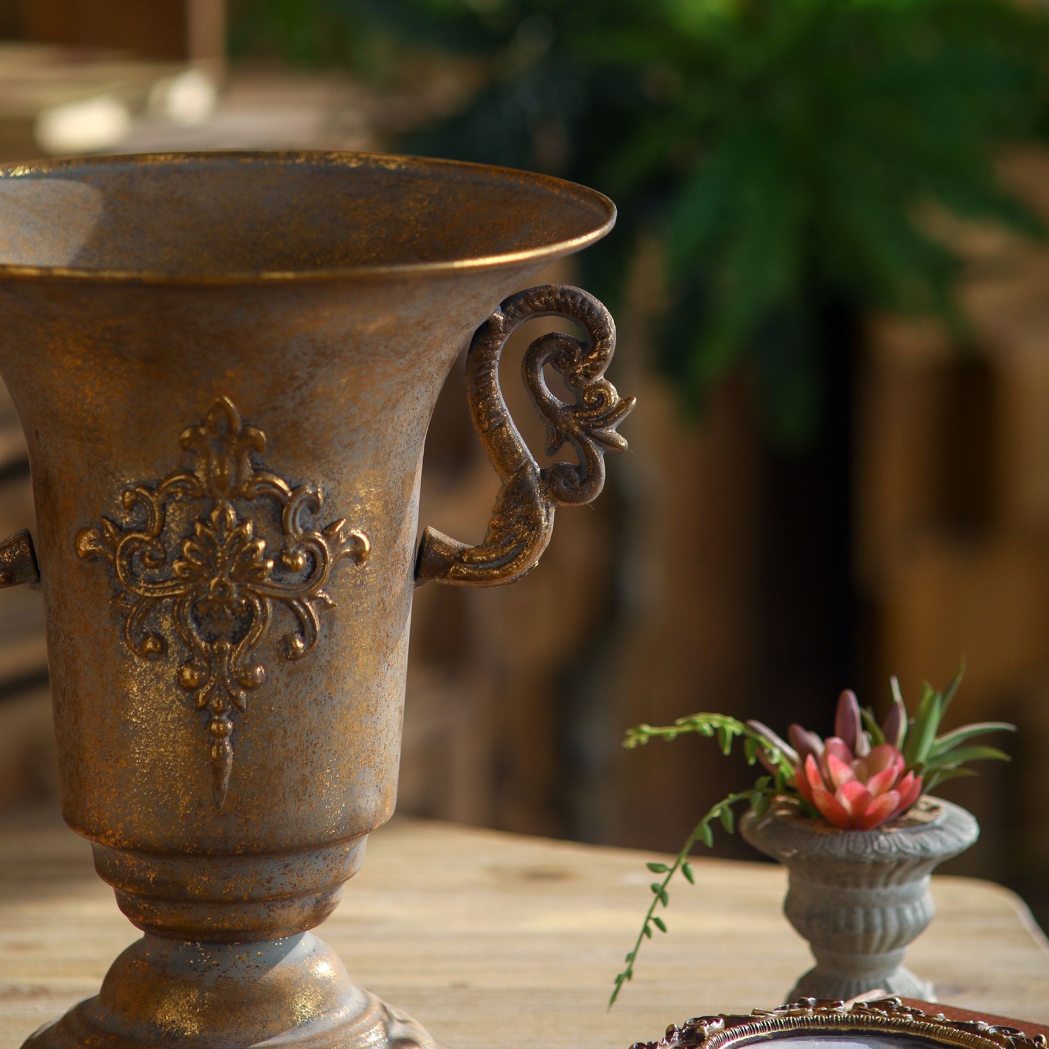 Capri urn vase side detail of the sculpted scroll handle and burnished patina