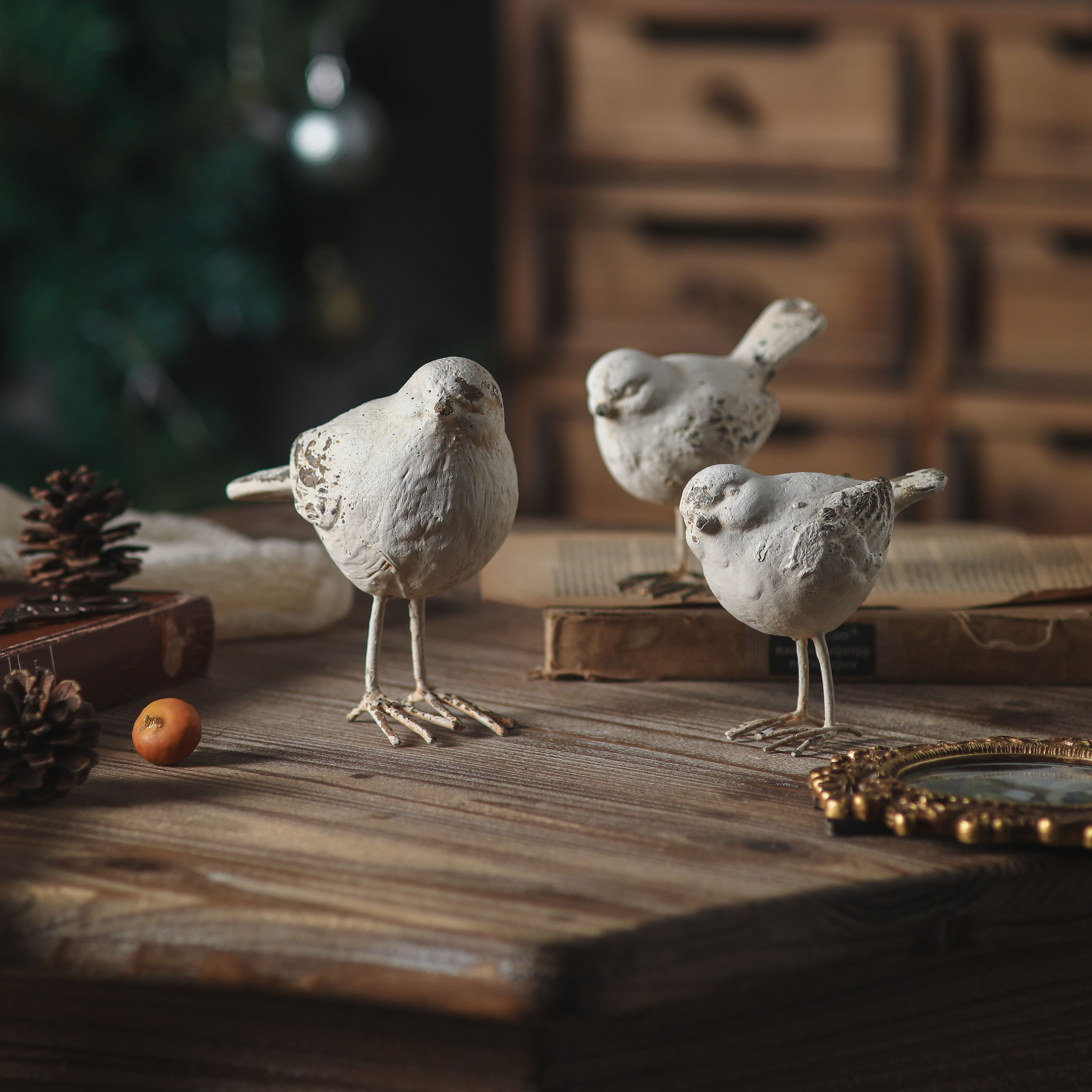 Gia bird figurine set of 3 in distressed white on a rustic timber table. Hero.