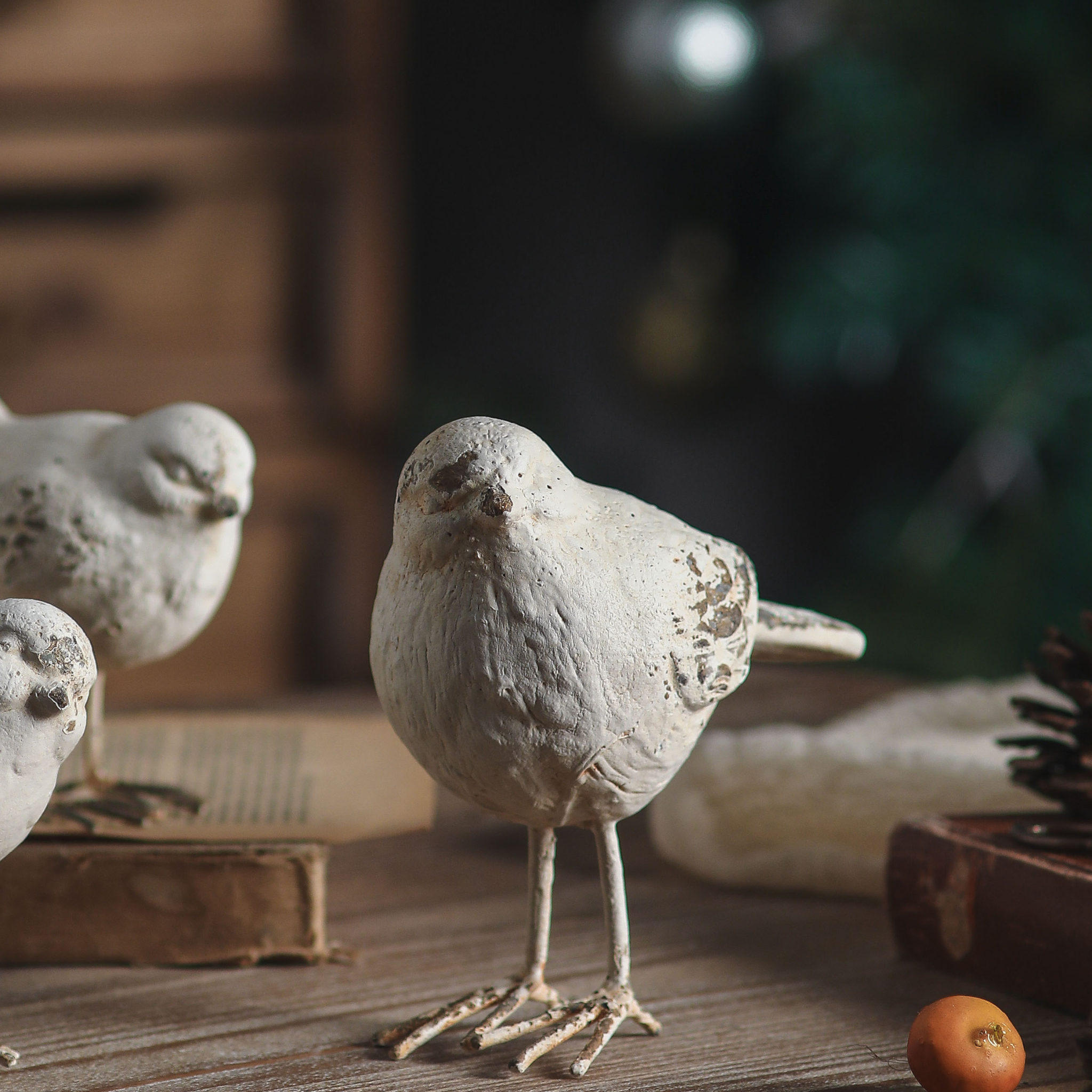 Gia large bird close-up showing the distressed white finish and wire legs