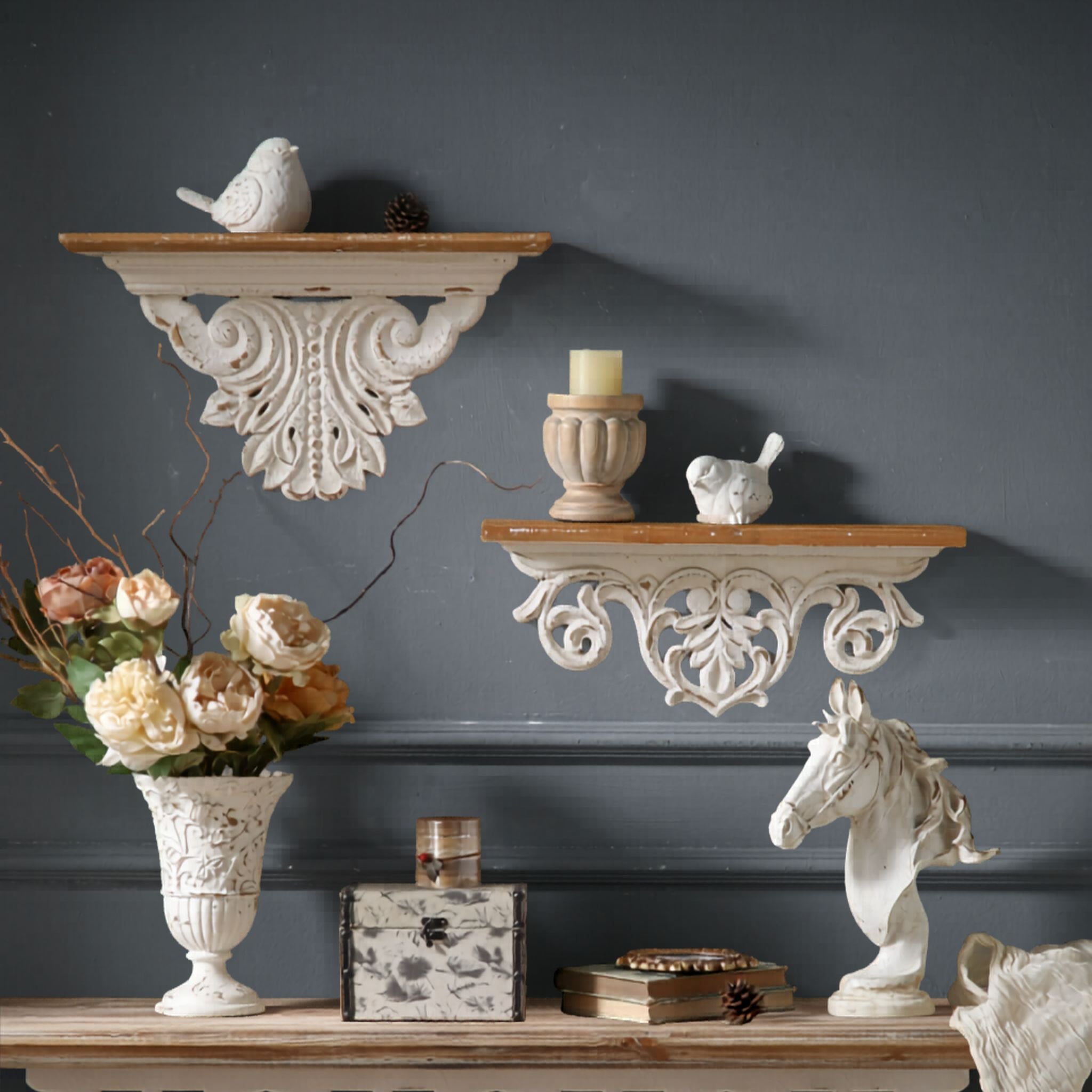 Virginie French Provincial mantel shelf in distressed whitewash with carved scroll apron and timber top, styled on a charcoal wall above a console with flowers and decor.