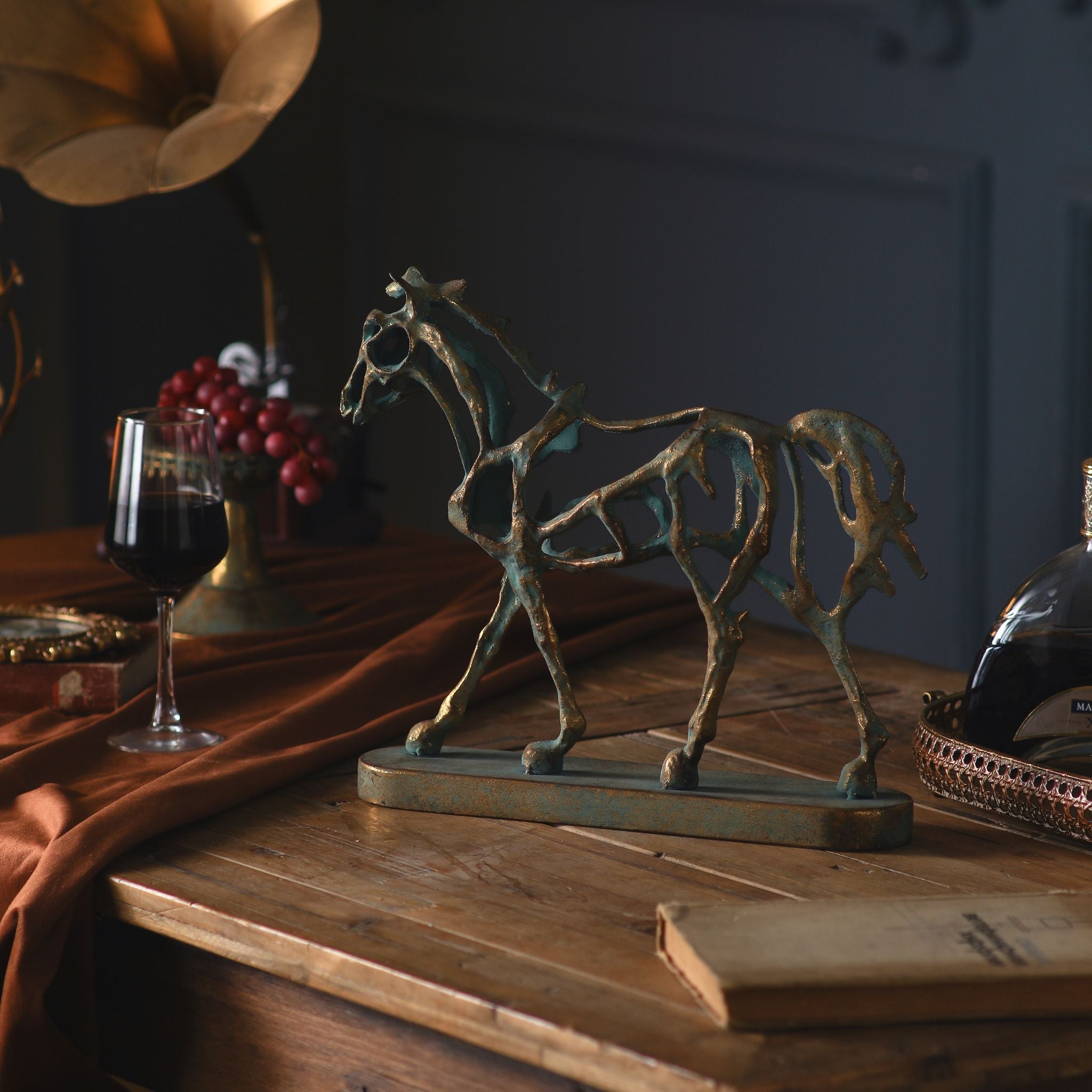 Front three-quarter view of the Jules openwork horse, styled with wine and grapes