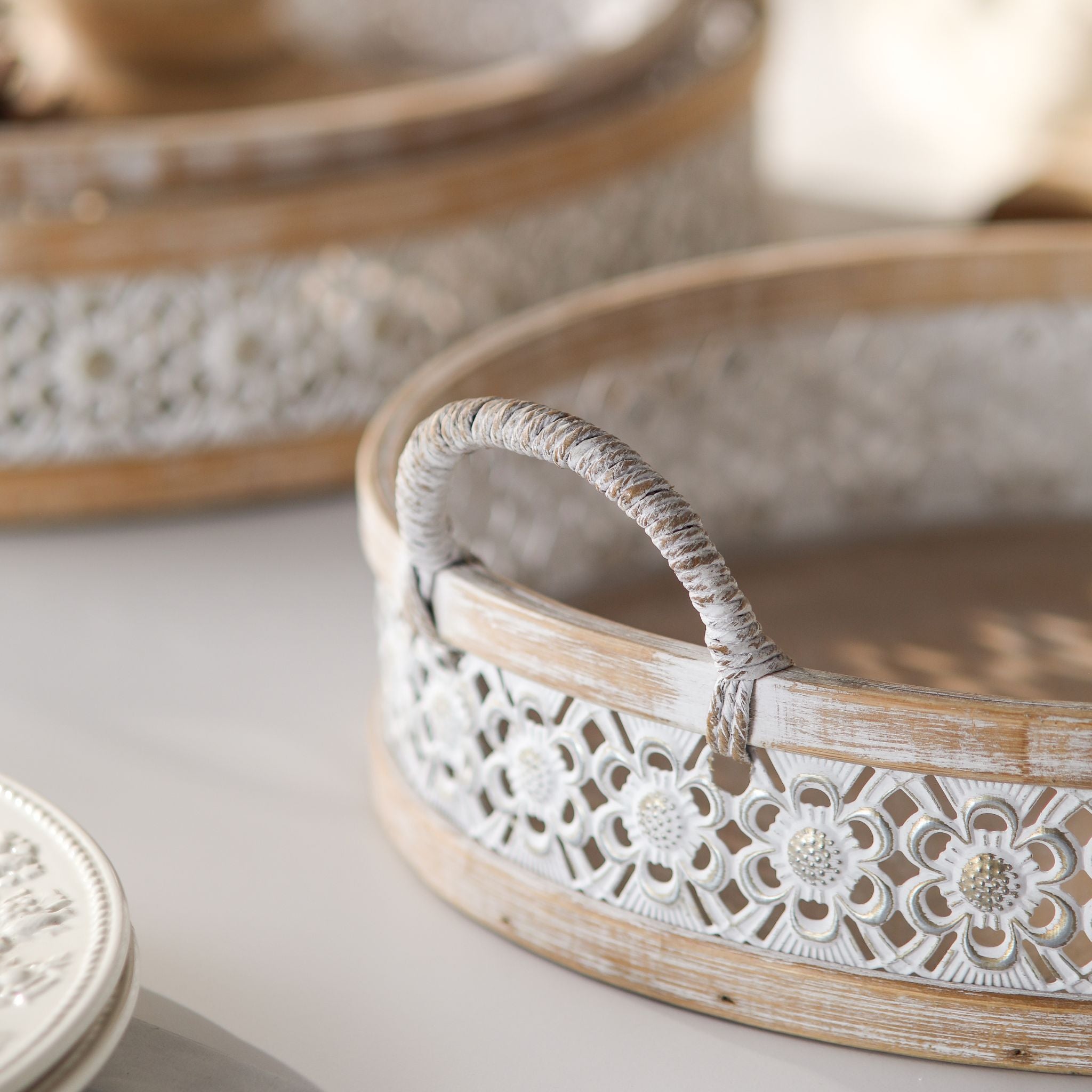 Close detail of an Alexandrine tray rope-wrapped handle and the pierced white floral metal band
