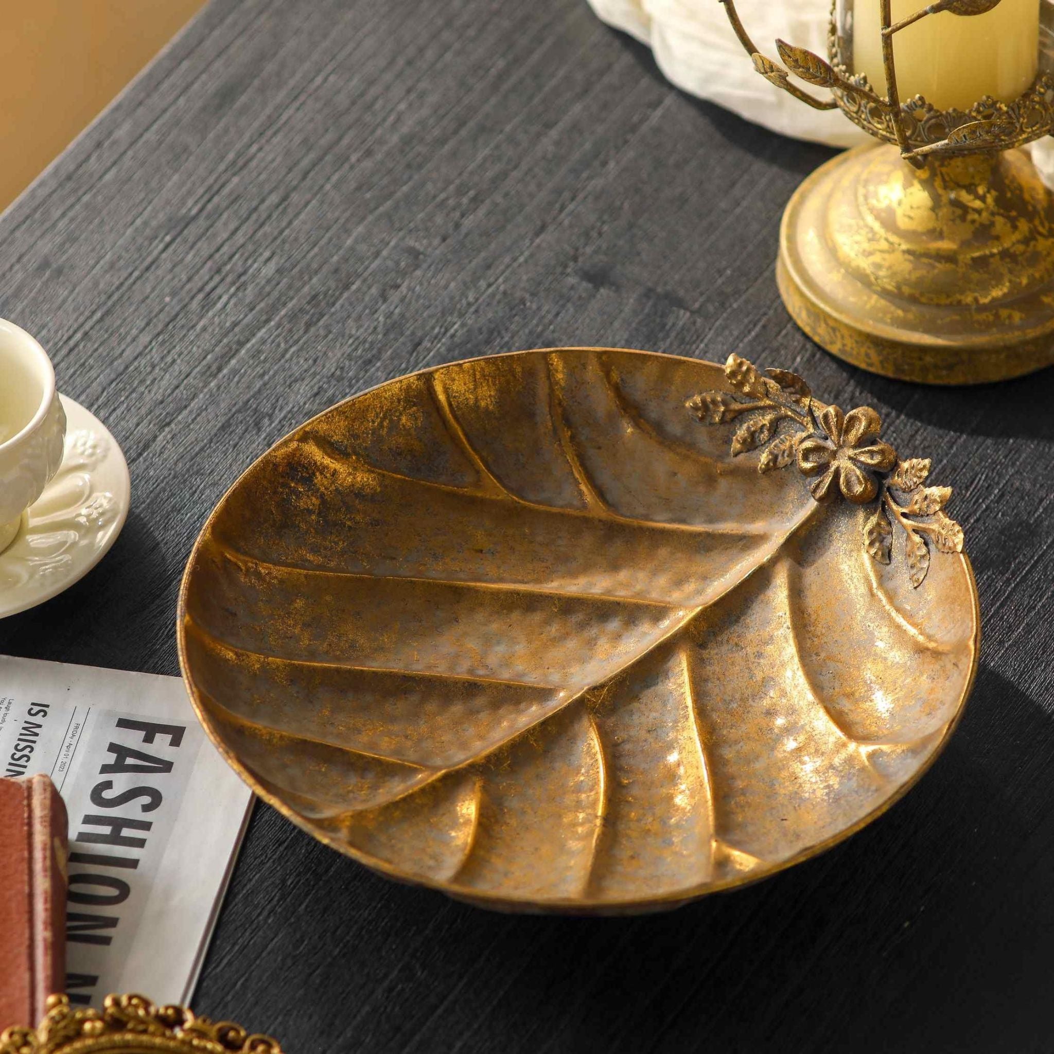 Alida French Provincial leaf-shaped dish in antique gold metal, pressed leaf veins with a raised flower and leaf sprig on one edge