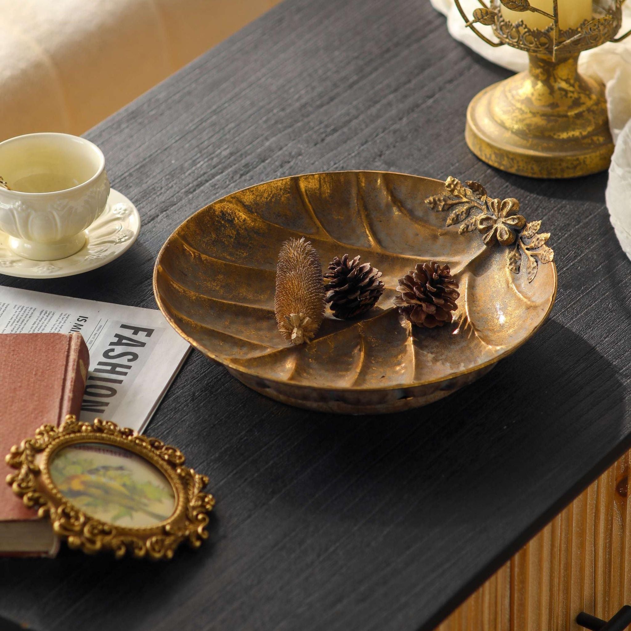 Alida leaf dish viewed from above holding pinecones, antique gold finish with leaf veins