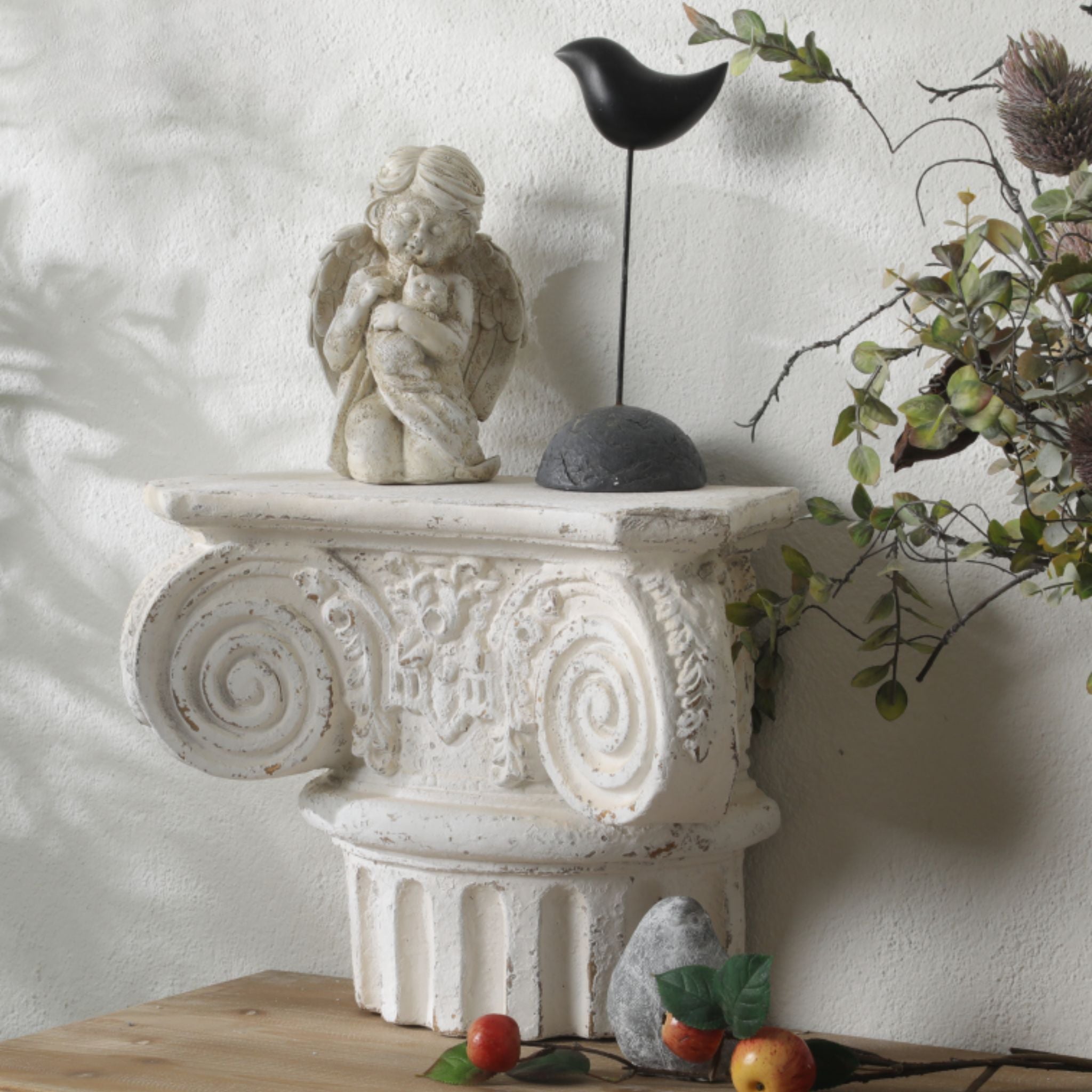 Aline corbel wall shelf styled with a cherub figure, dried foliage and fruit in a French Provincial vignette.
