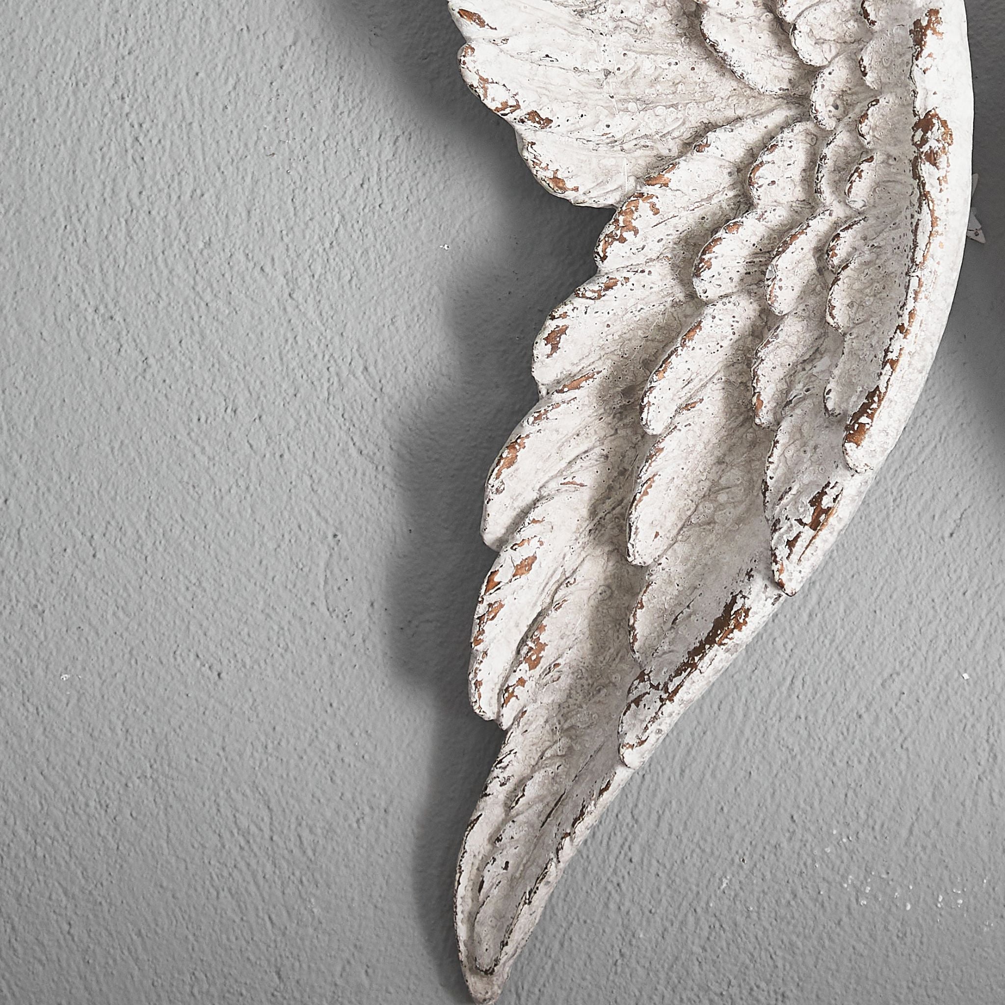 Close-up of the moulded feather detail and distressed white finish on an Alora wing.