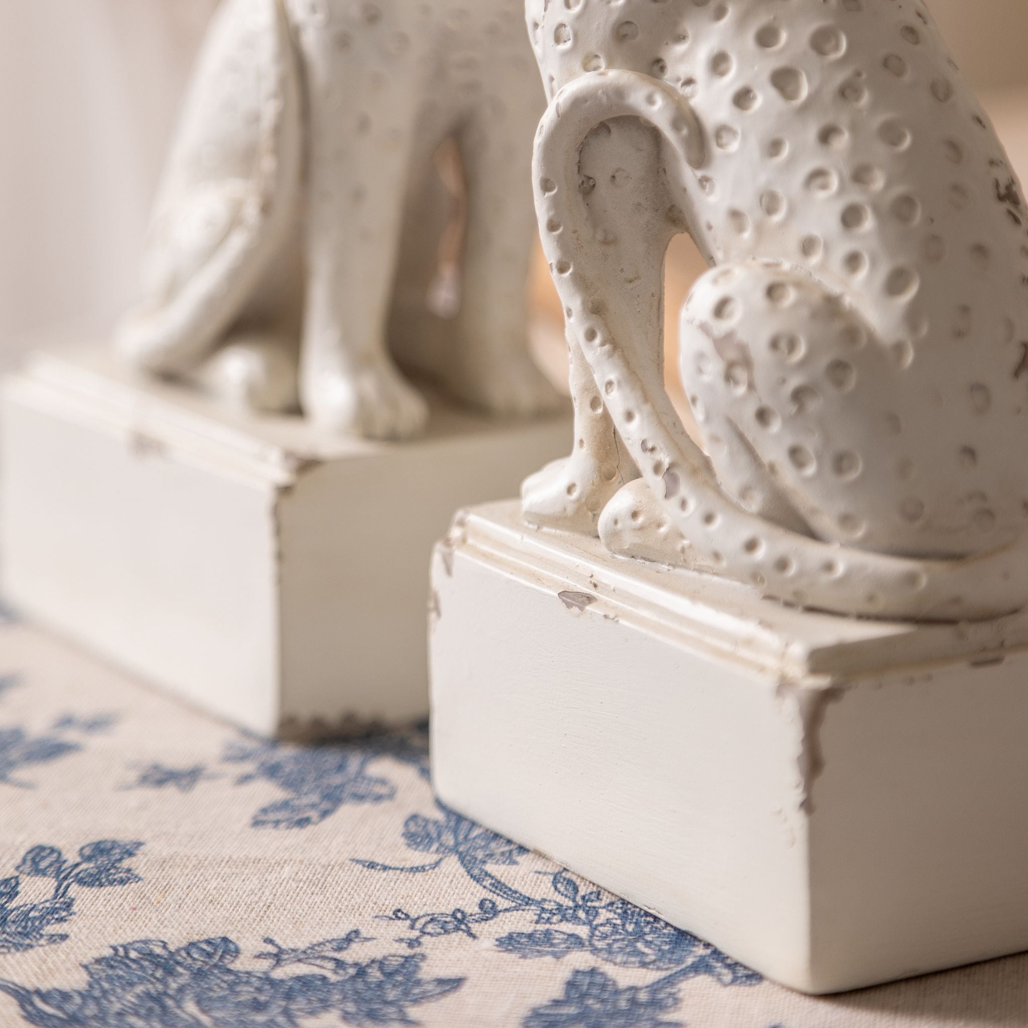 Close-up of the Amandine leopard bookend dimpled spot texture and plinth base in antique white