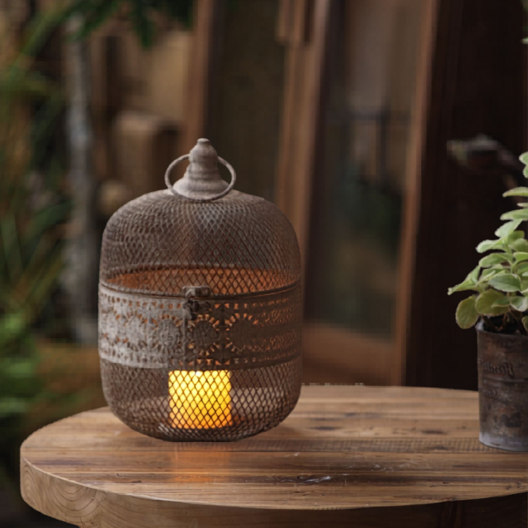 Amani mesh dome lantern glowing on a side table in a styled setting