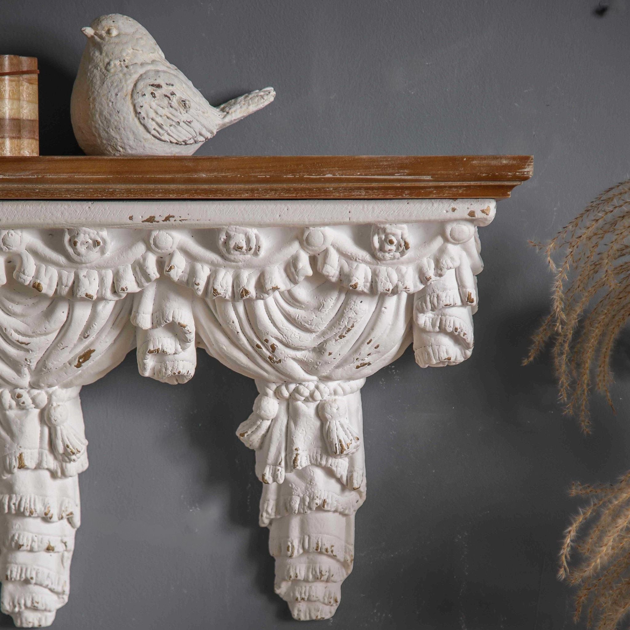 AClose-up detail of Annie's draped panel terminals showing the tied-tassel scroll and pleated curtain fold