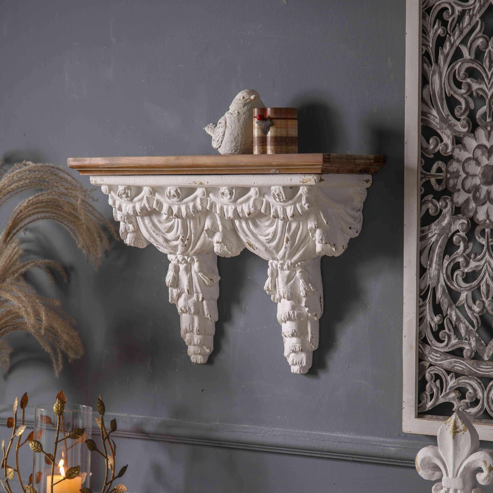 Side angle of Annie wall shelf showing the three-dimensional drapery carving and depth of the swag detail