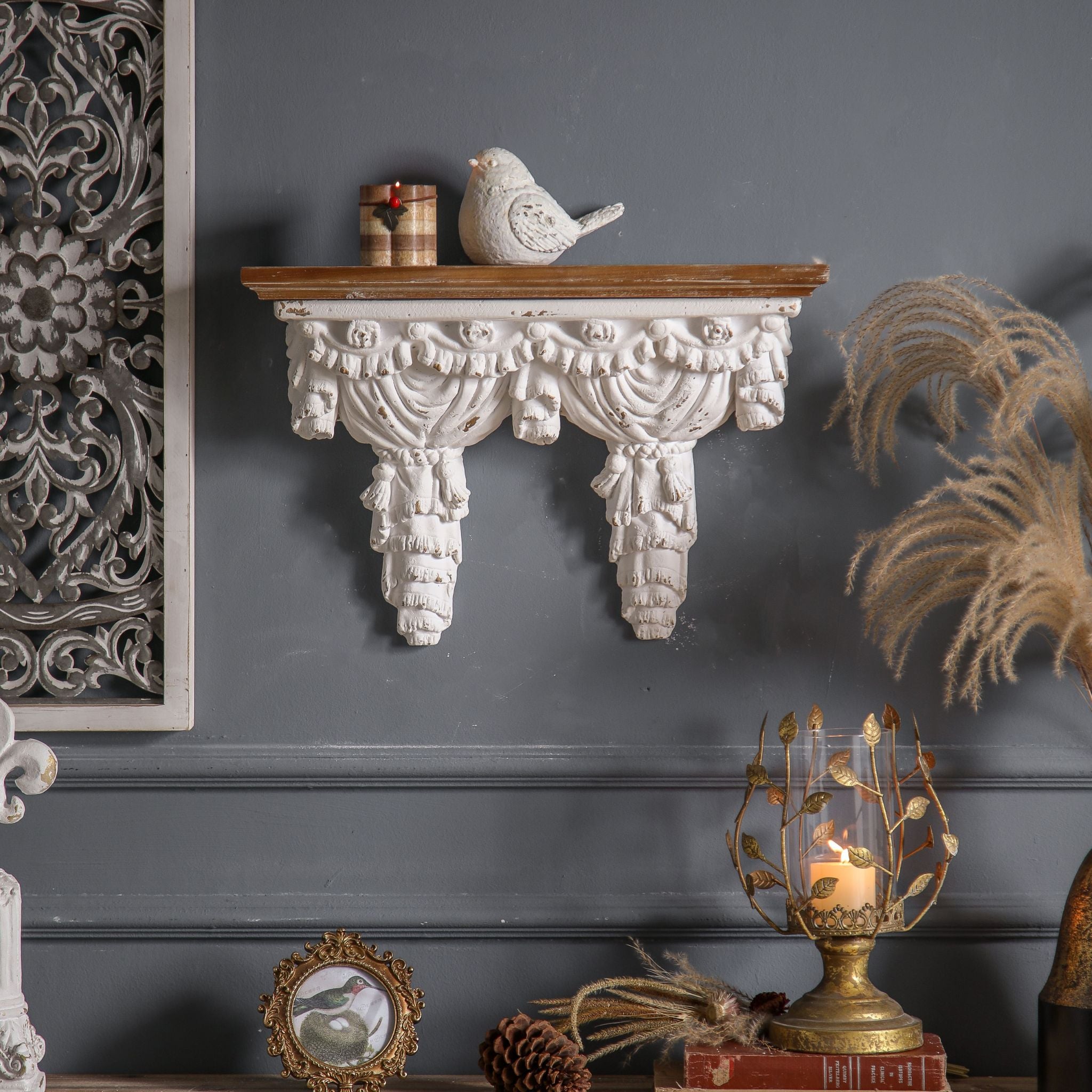 Annie draped curtain wall shelf mounted solo on a charcoal wall, full piece visible with carved swag valance and tasseled panel terminals