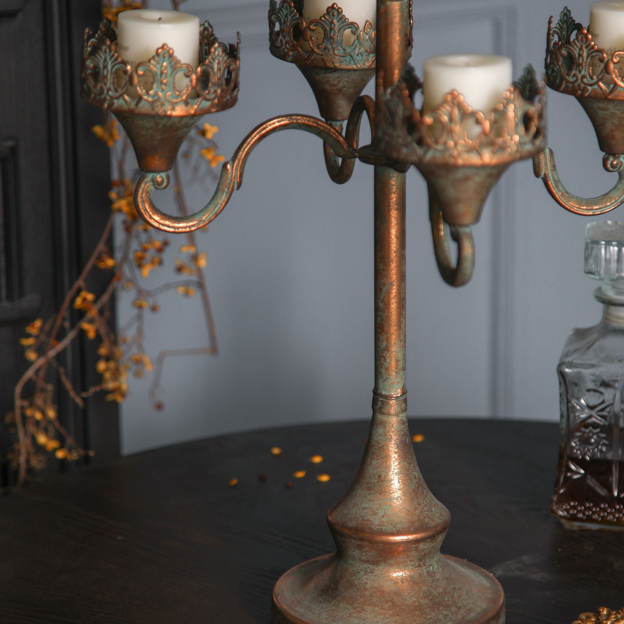 Close-up of the filigree crown collar and scrolled arm on the Corrine candelabra.