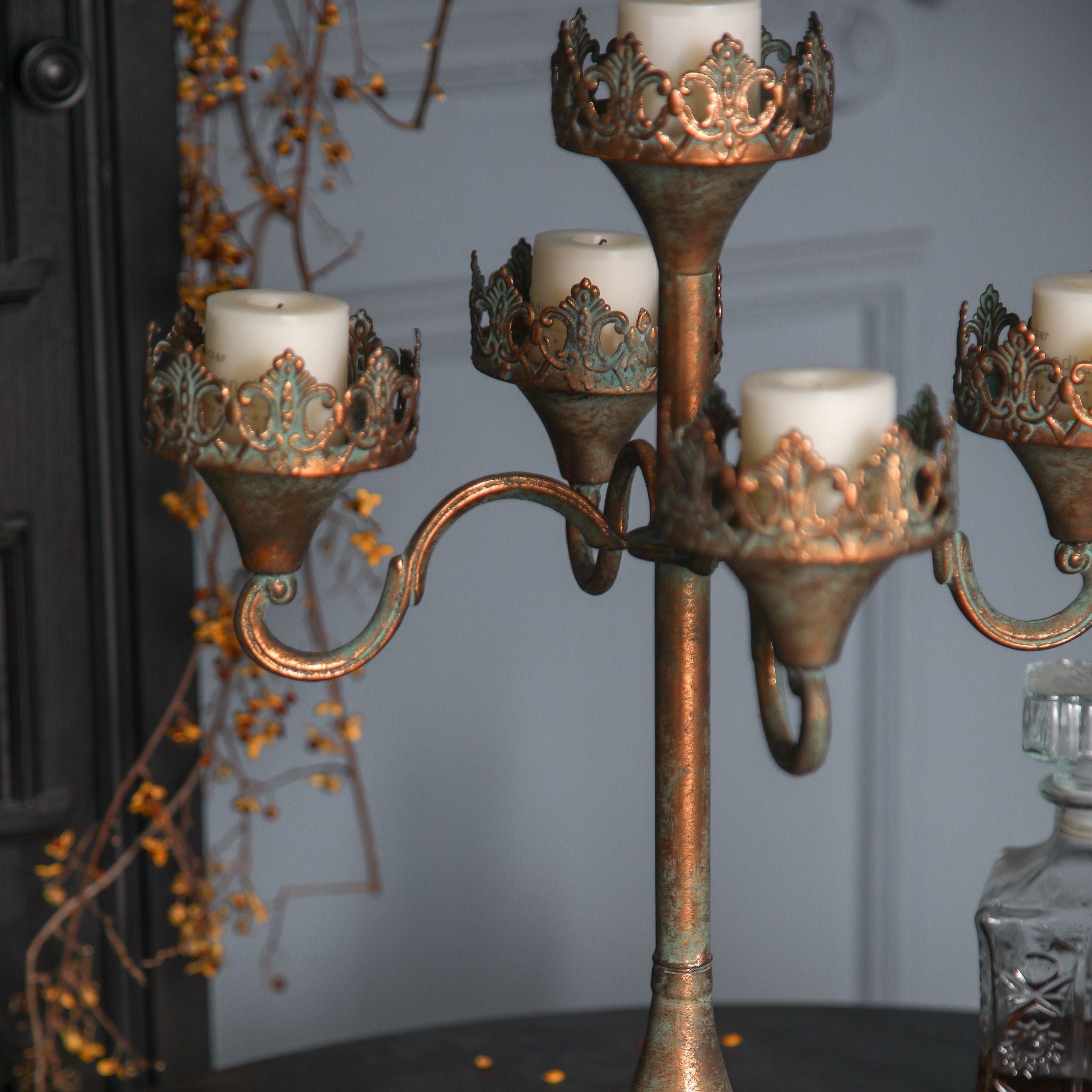 Close-up of the filigree crown collar and scrolled arm on the Emma candelabra.