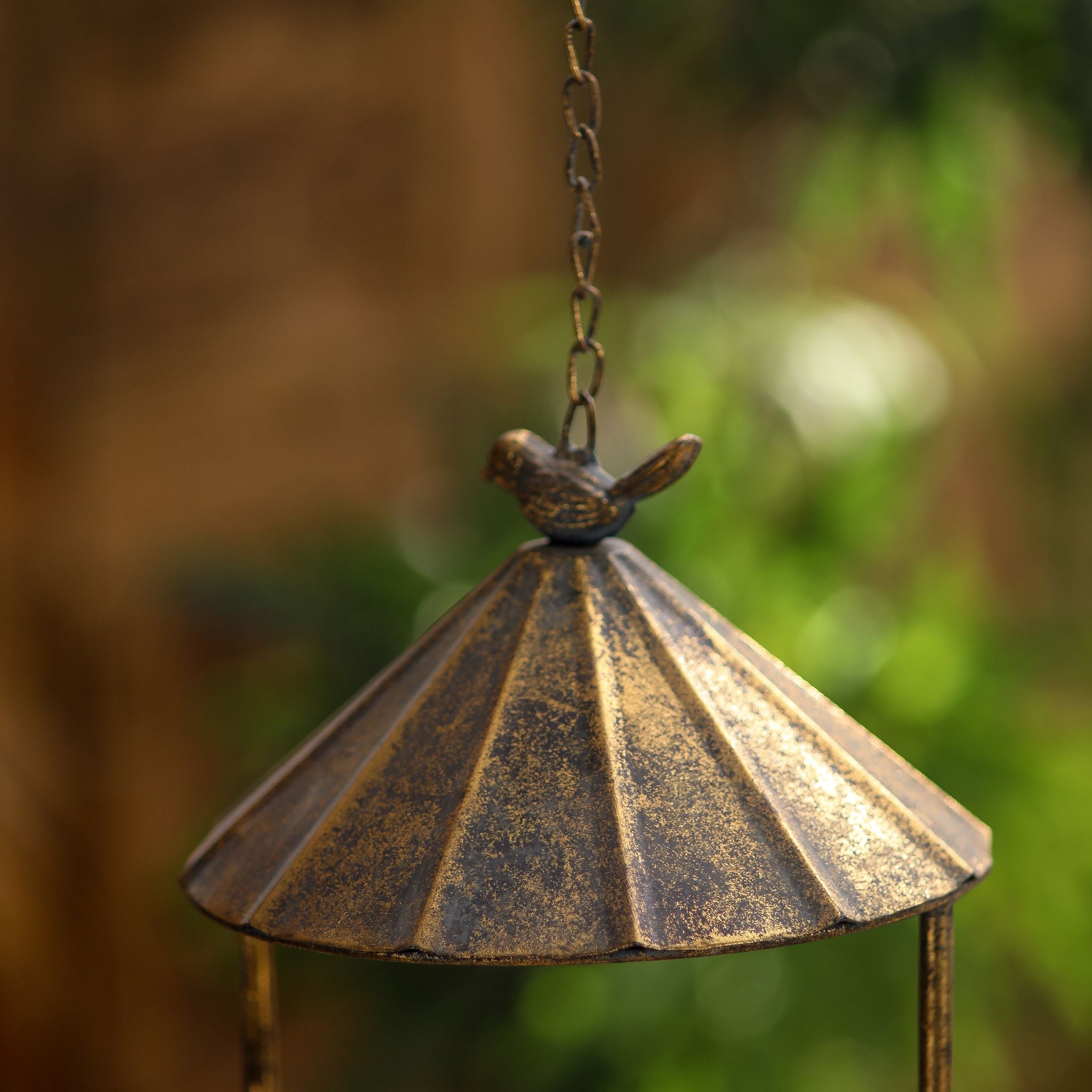 Close-up of the fluted roof and little cast bird finial on the Nathalie hanging feeder.